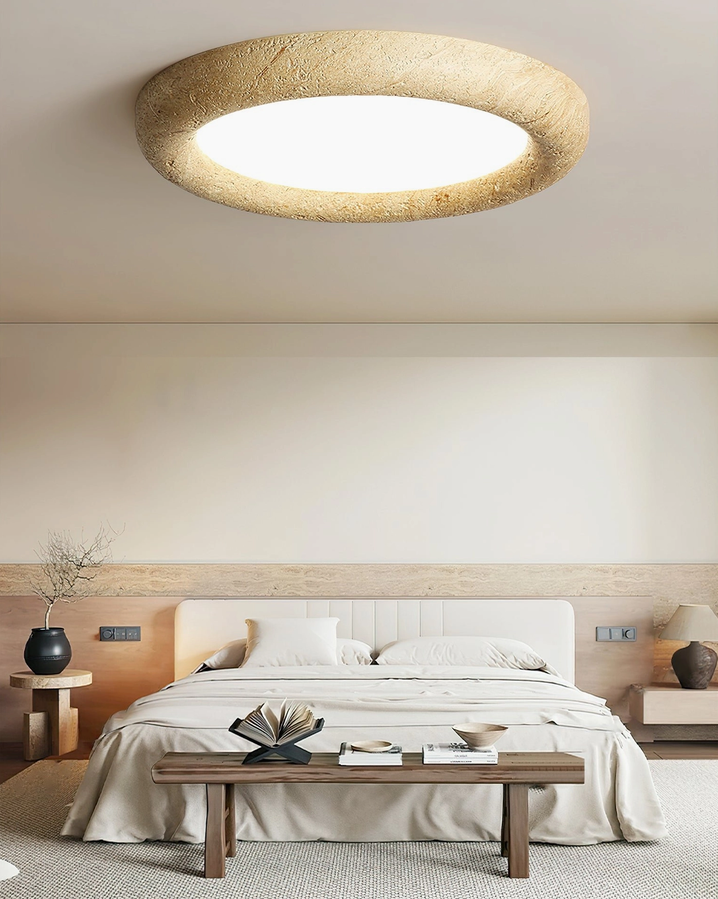 Flush mount stone ceiling light above wooden bedroom furniture and decorative table