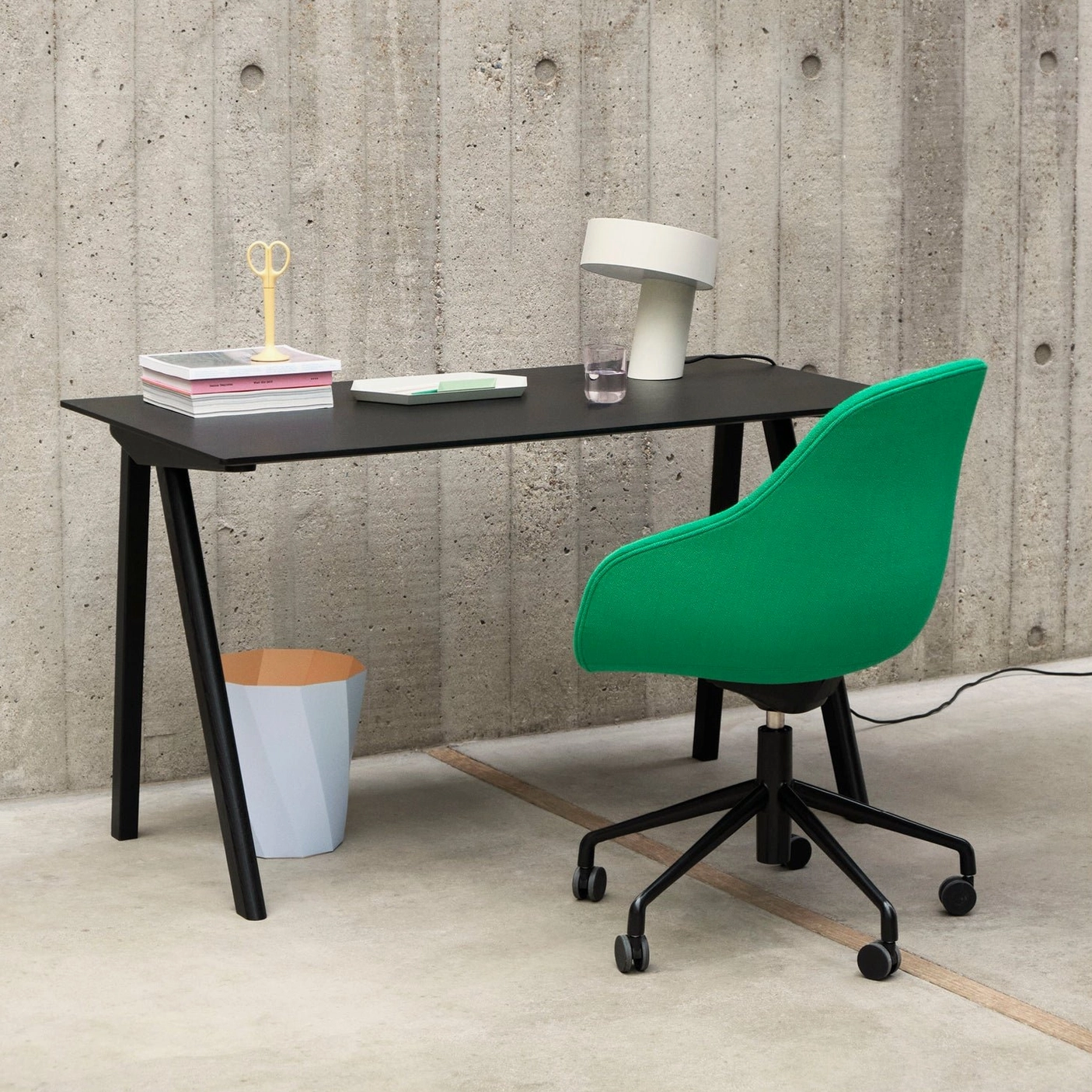 White Celia table lamp on modern home office desk with bright green chair and stacked books, contemporary work space