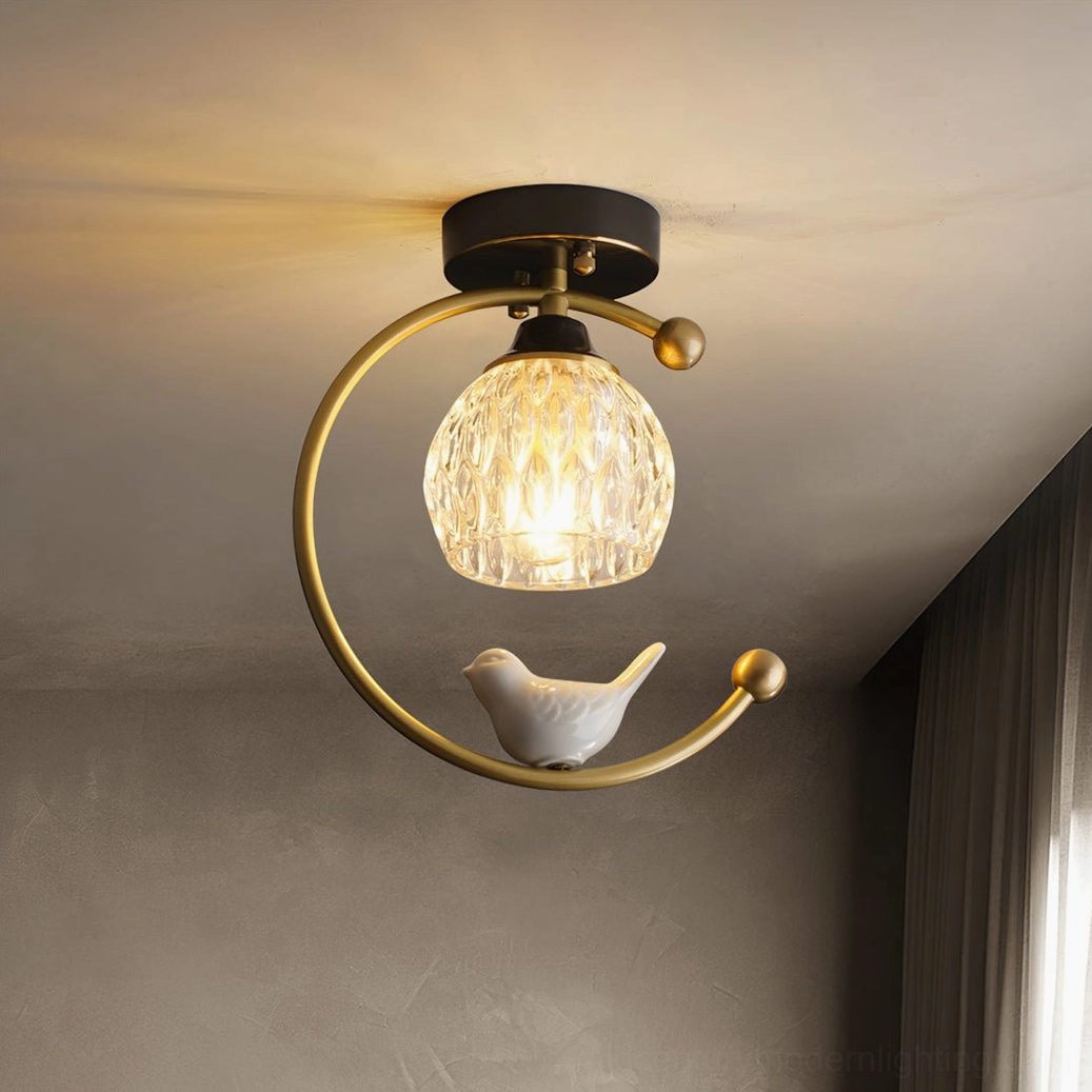 Handcrafted ceramic bird detail on flush mount ceiling lamp with warm illumination