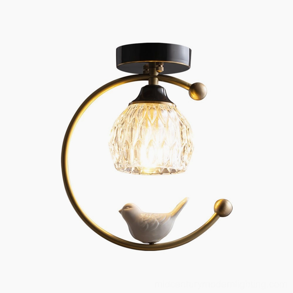 Ceramic bird ceiling lamp illuminated at dusk creating ambient warm lighting atmosphere