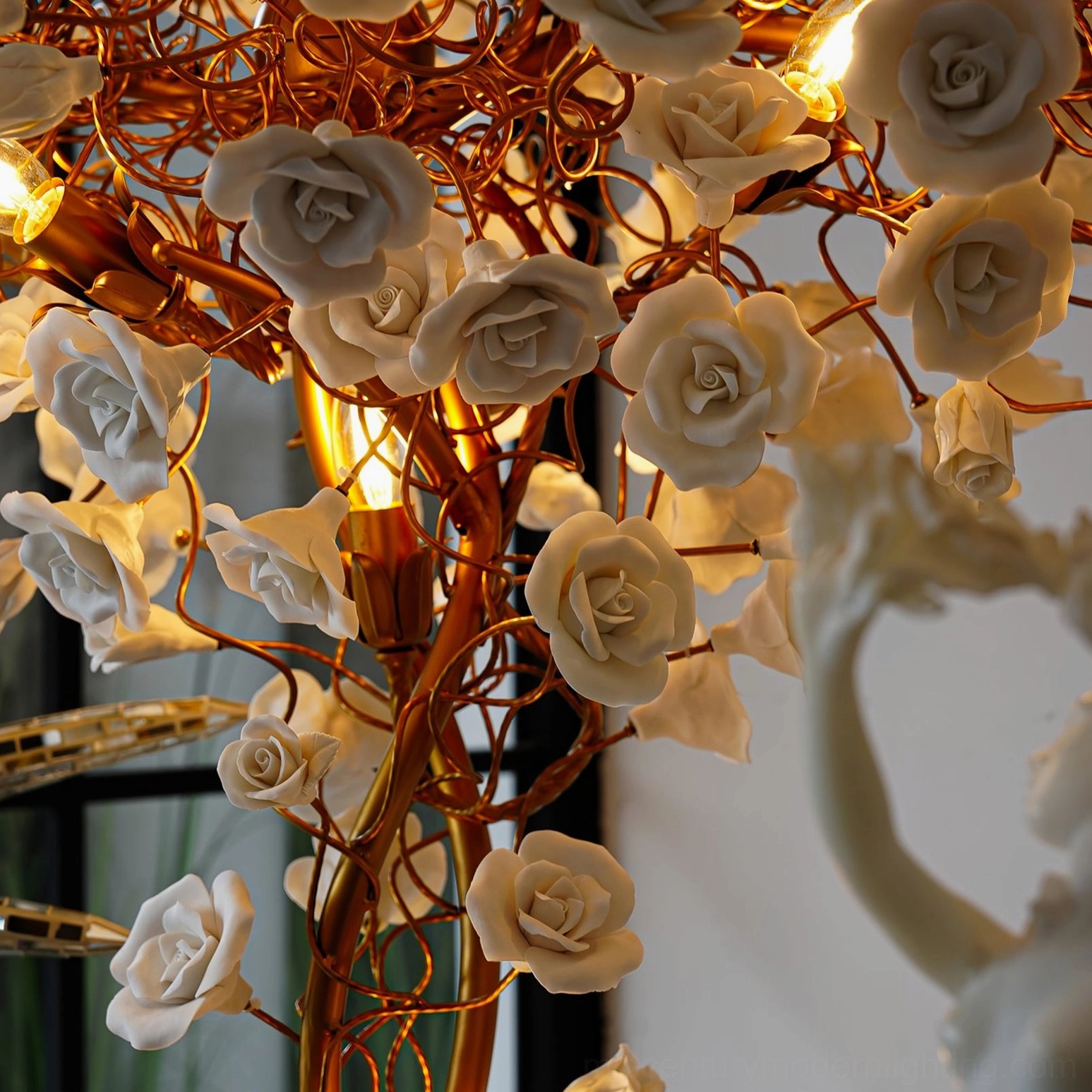 Detailed close-up of ceramic flower lamp showing gold branches and beige ceramic roses with warm decorative lighting