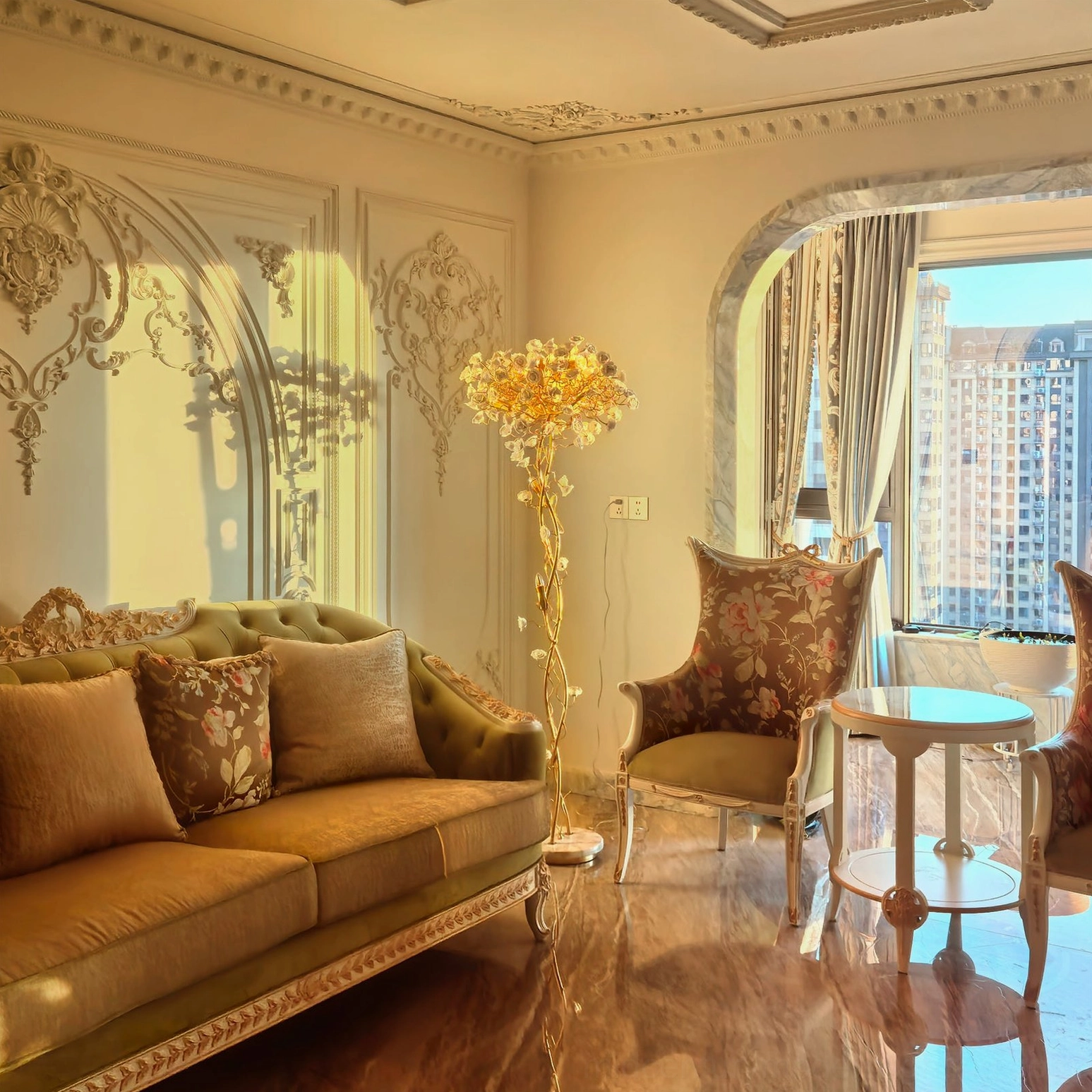 Wide view of ceramic flower brass floor lamp in bright European-style living room with leather sofa and coffee table