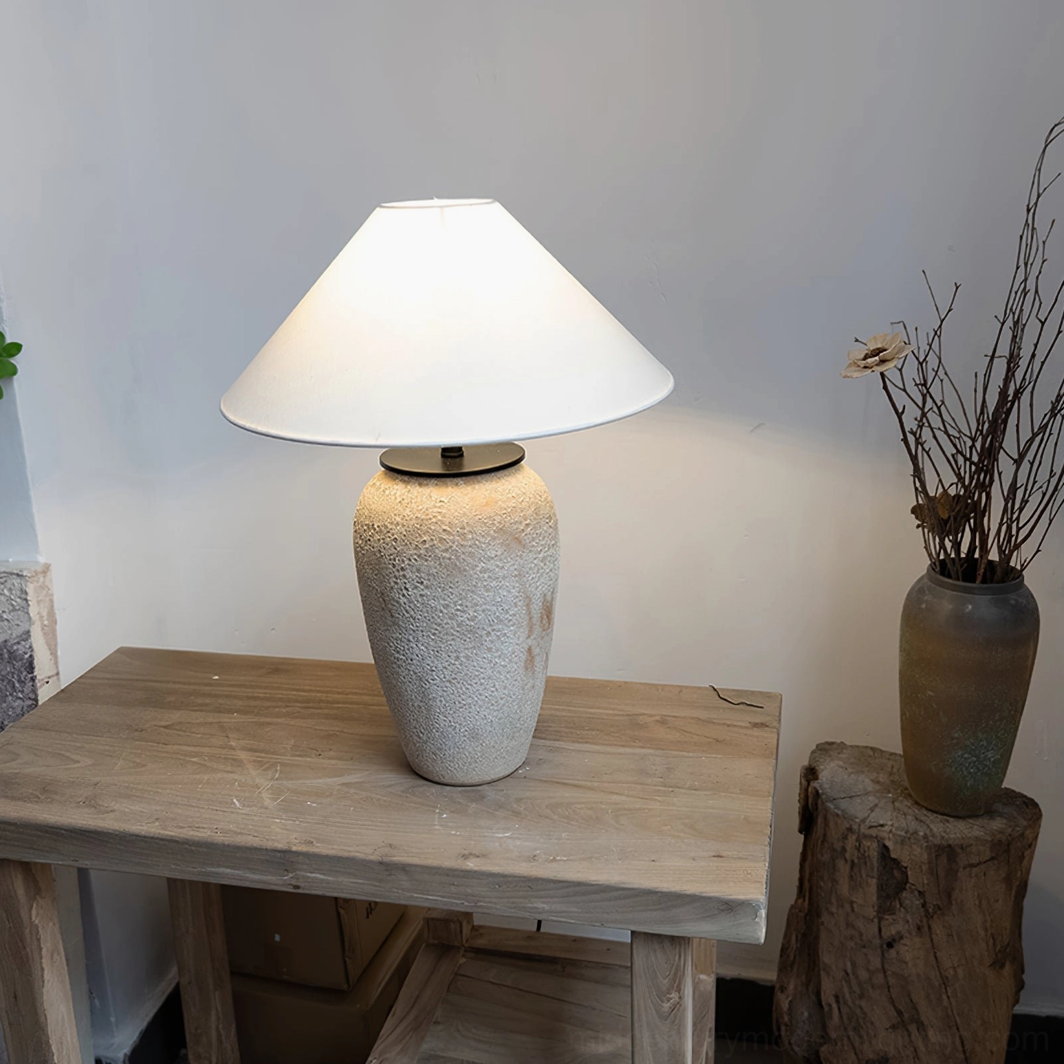 Artisan ceramic lamp with rustic dried flowers and wooden accessories in minimalist home decor