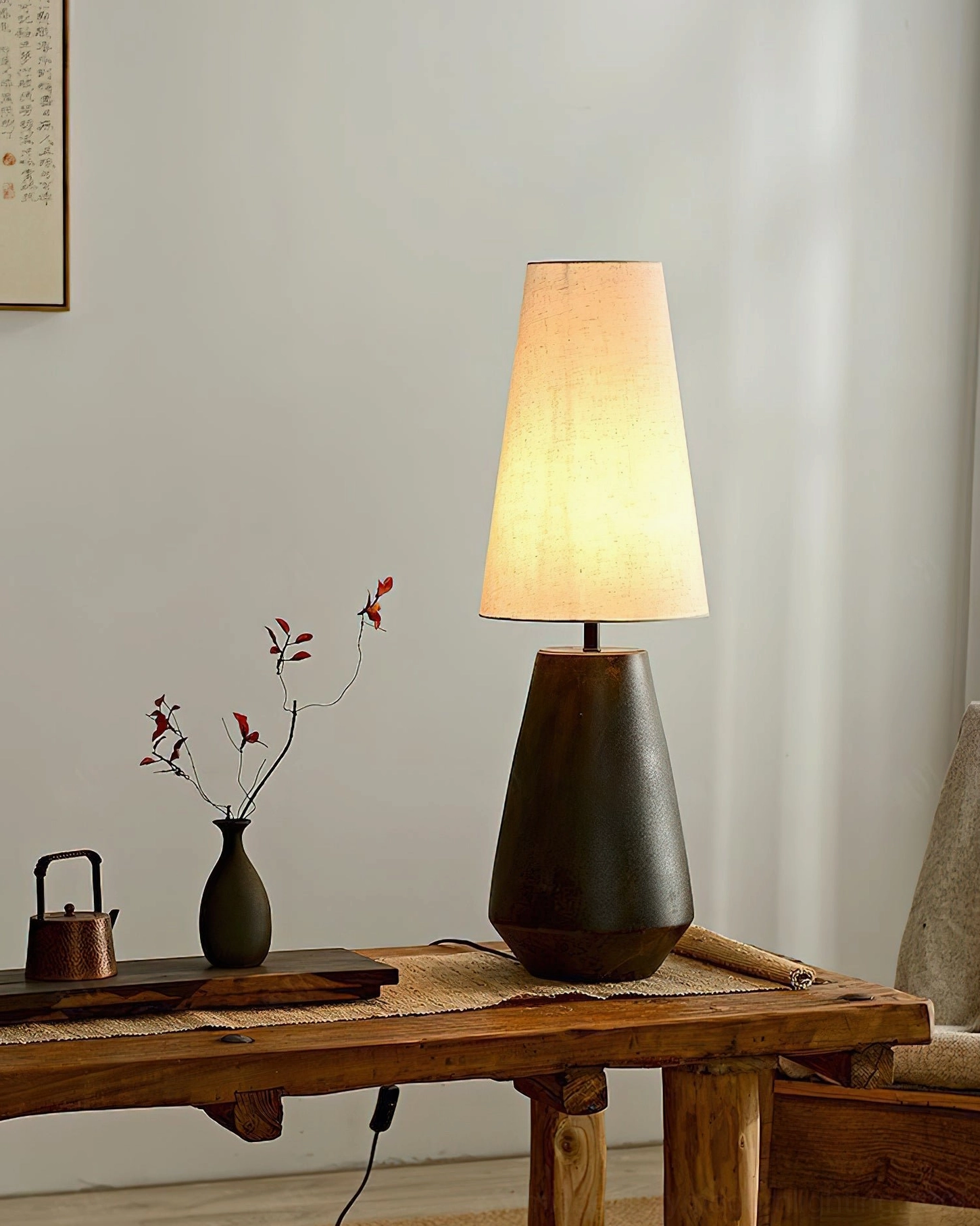 Handcrafted ceramic tapered table lamp showing aged matte finish and proportional mid-century modern form