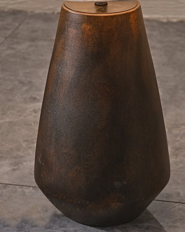 Close-up detail of aged rustic brown matte ceramic lamp base with tapered curved shape, showcasing artisanal ceramic craftsmanship
