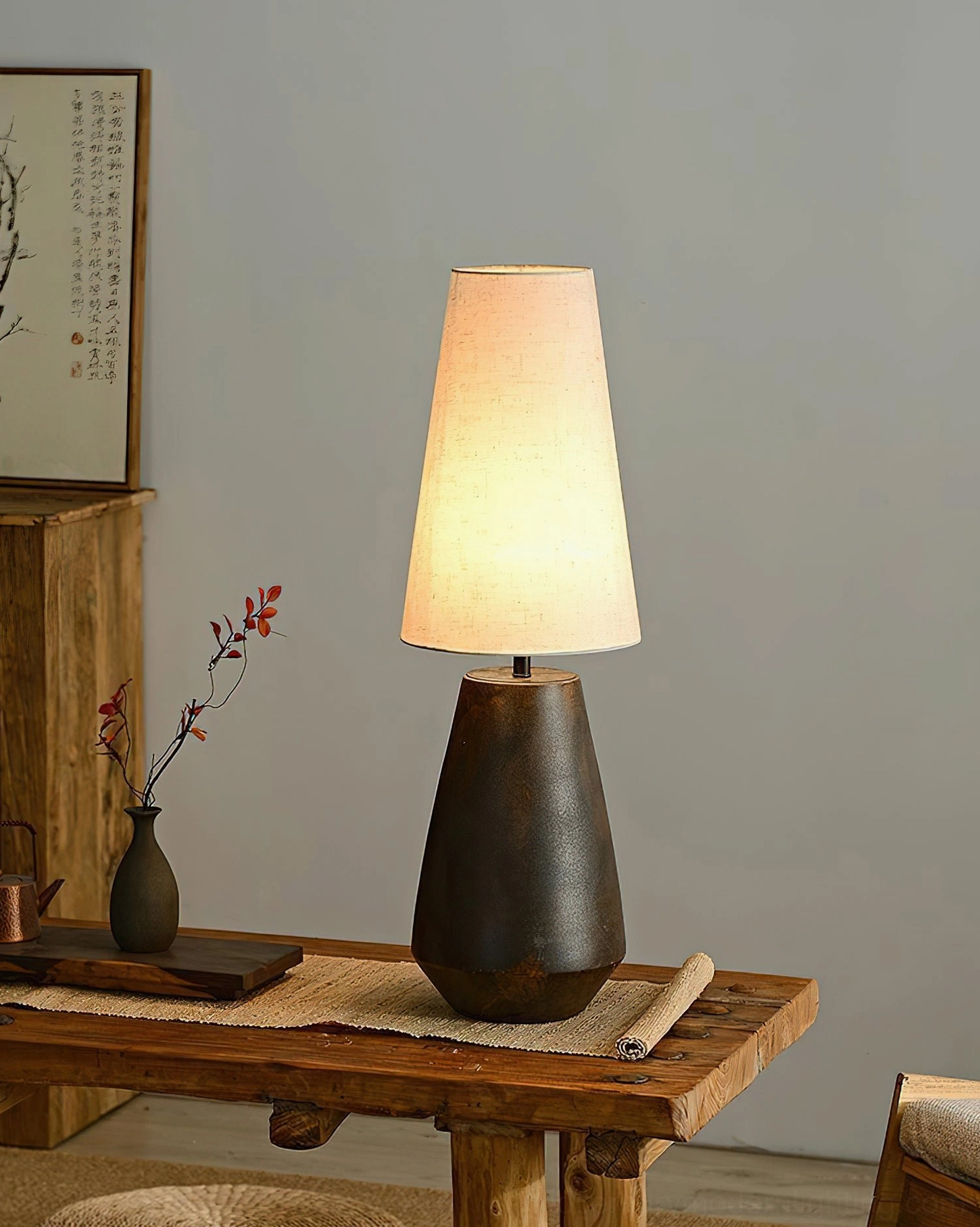 Ceramic tapered table lamp styled in minimalist interior setting, demonstrating Scandinavian design aesthetic