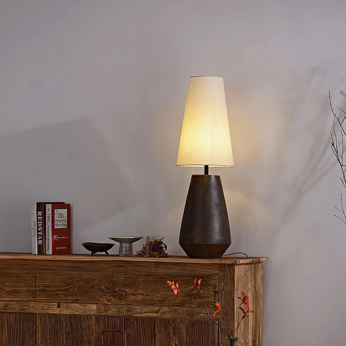 Mid-century modern ceramic table lamp with natural fabric shade, warm ambient lighting photography