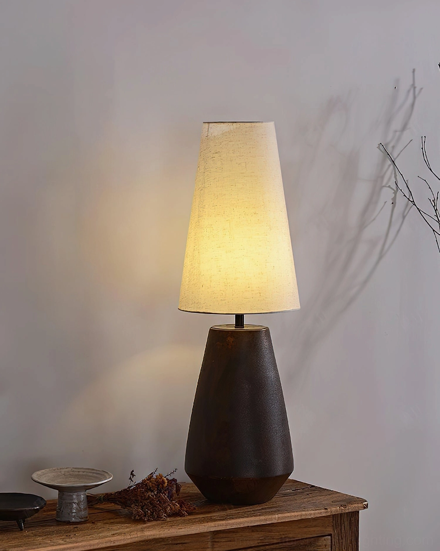 Full view ceramic tapered table lamp, rustic modern design with warm fabric shade lighting for home ambiance