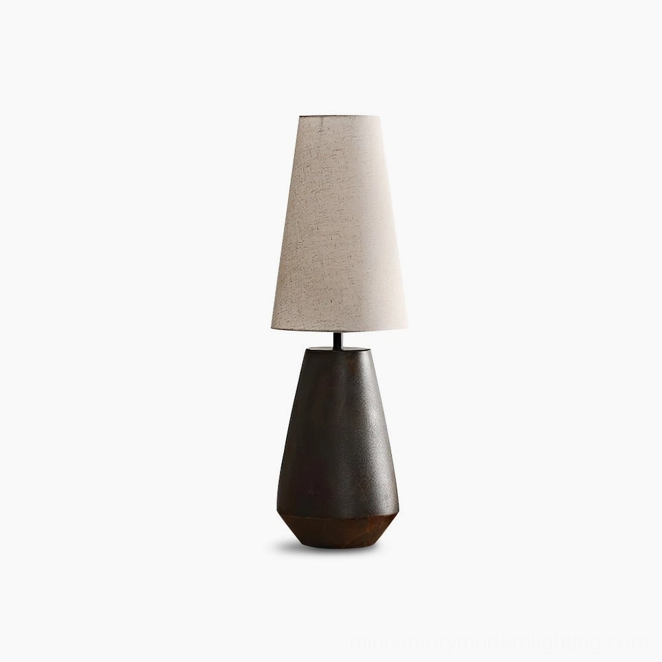 Ceramic tapered table lamp with rust-colored matte finish and beige fabric shade on white background, showcasing minimalist mid-century modern design