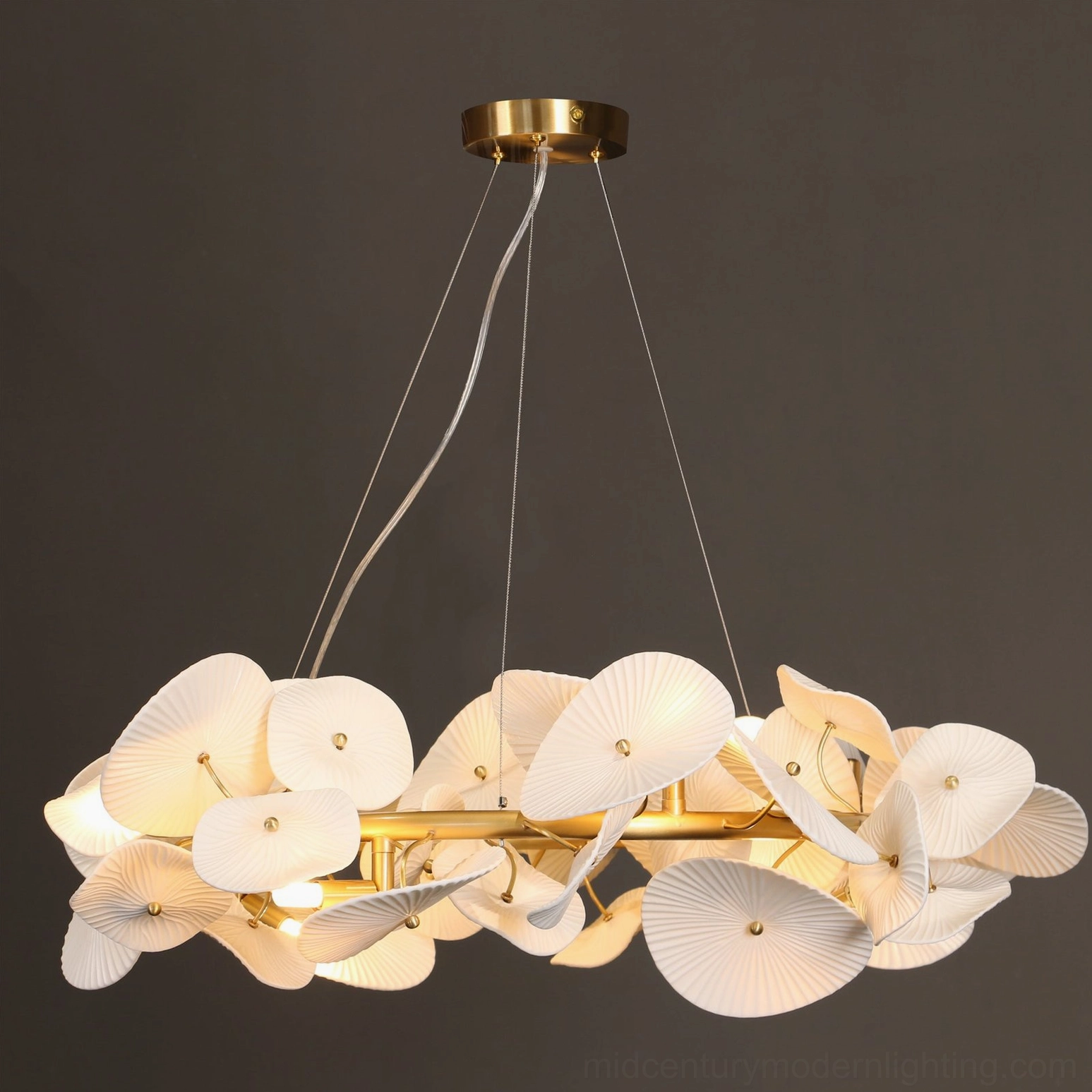 Lit ceramic wreath chandelier frontal low-angle view showcasing elegant modern luxury design with warm ambient illumination