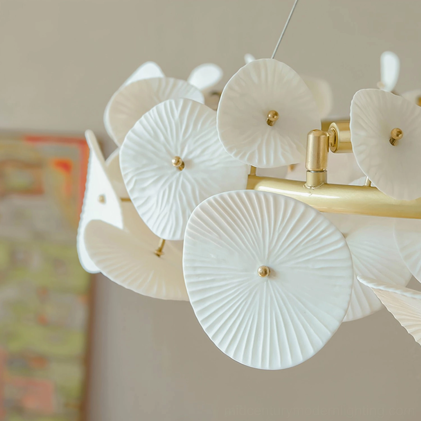 Close-up detail of ceramic wreath chandelier petals showing intricate leaf-vein texture and gold metal fixture joints