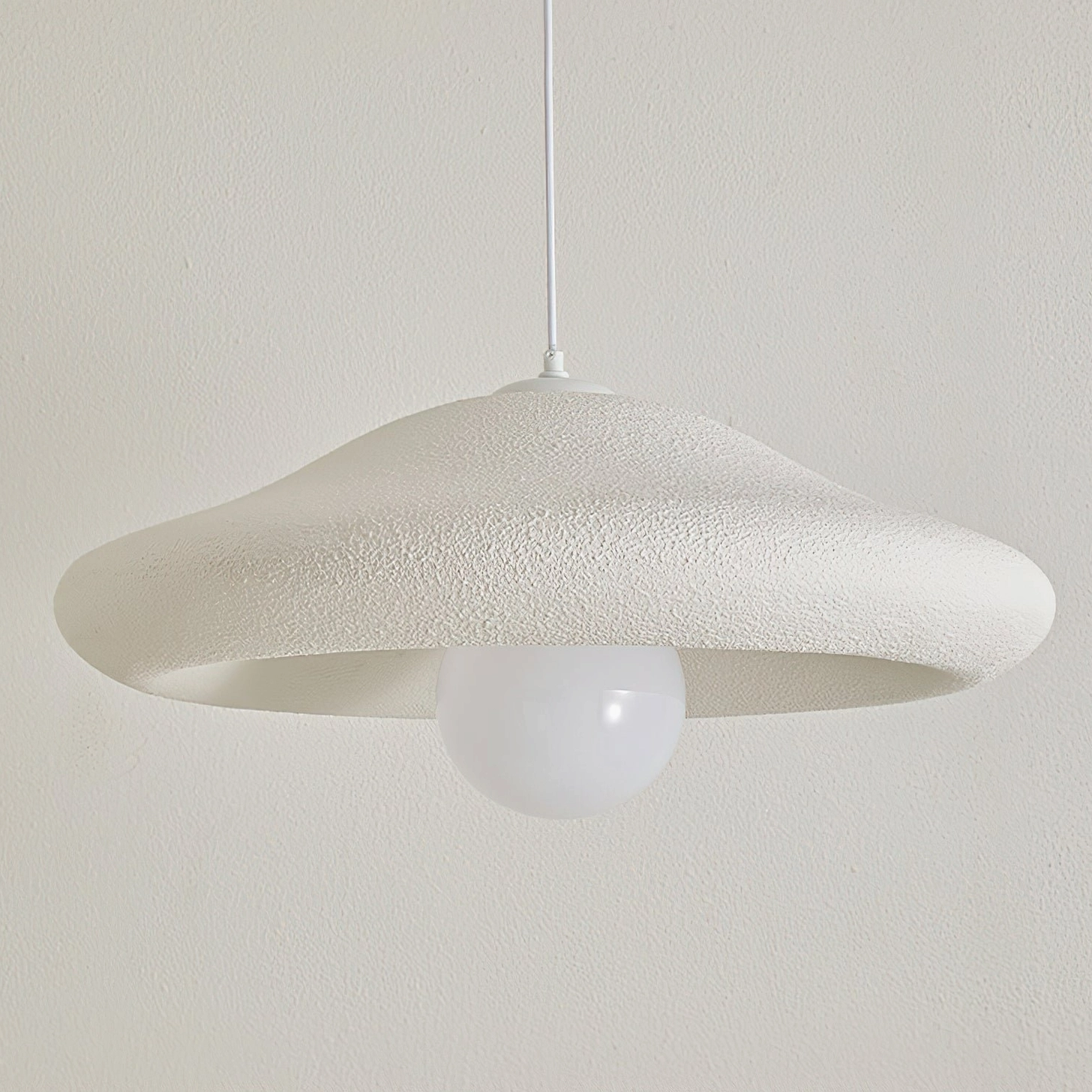 Front view of Chalk pendant light with matte white textured shade and concealed hanging cord