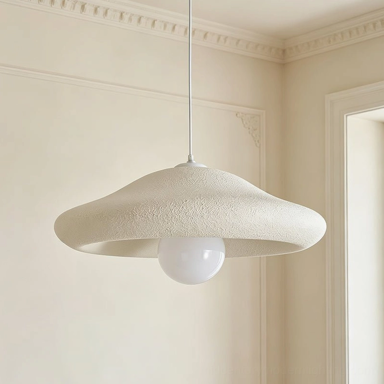 Close-up of Chalk pendant light textured plaster finish showing centered warm glowing bulb detail