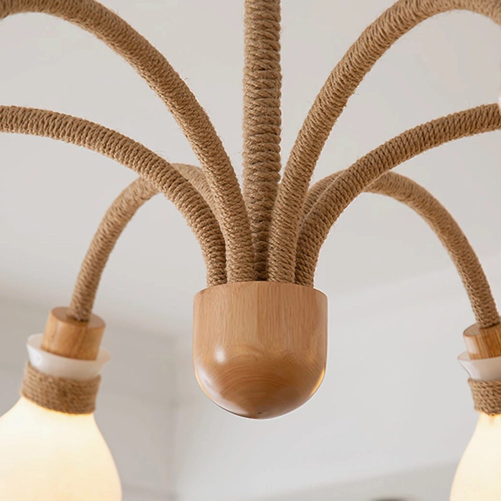 Close-up detail of chandelier arm assembly showing jute-wrapped metal arms and solid wood joint construction