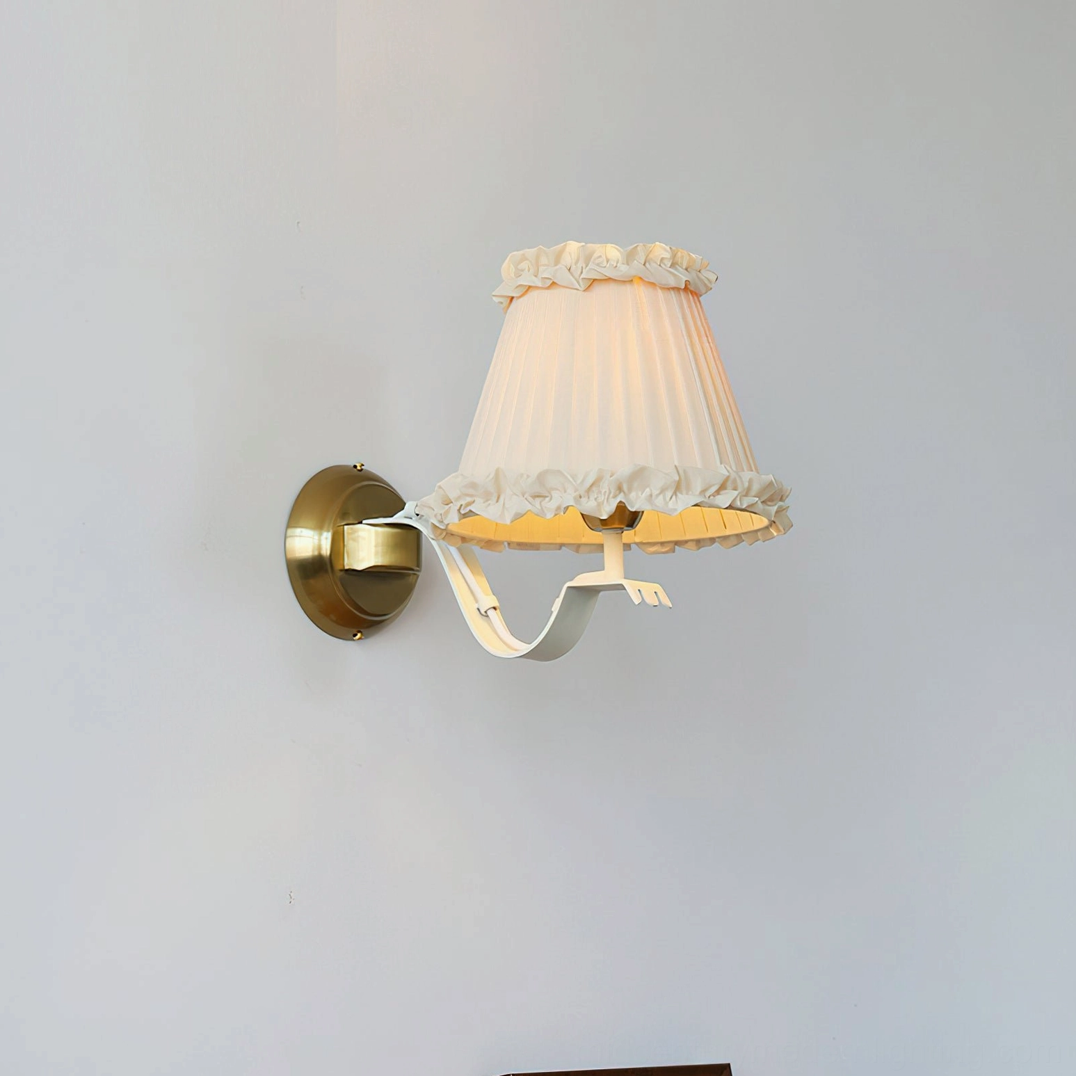 Chantal sconce mounted in bedroom vanity setting with vintage mirror and decorative accessories