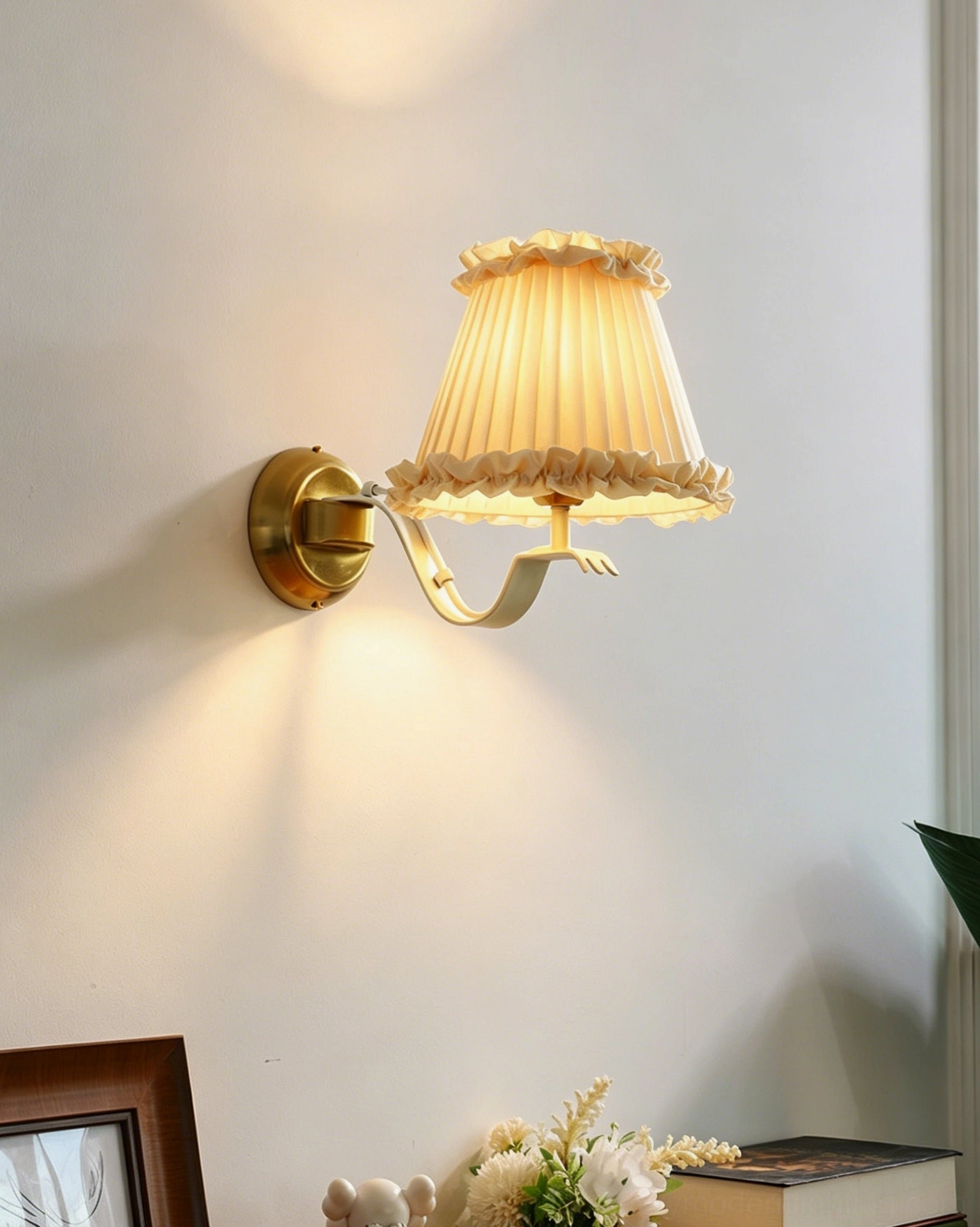 Chantal ruffle sconce with brass bracket detail mounted on minimalist wall with framed art