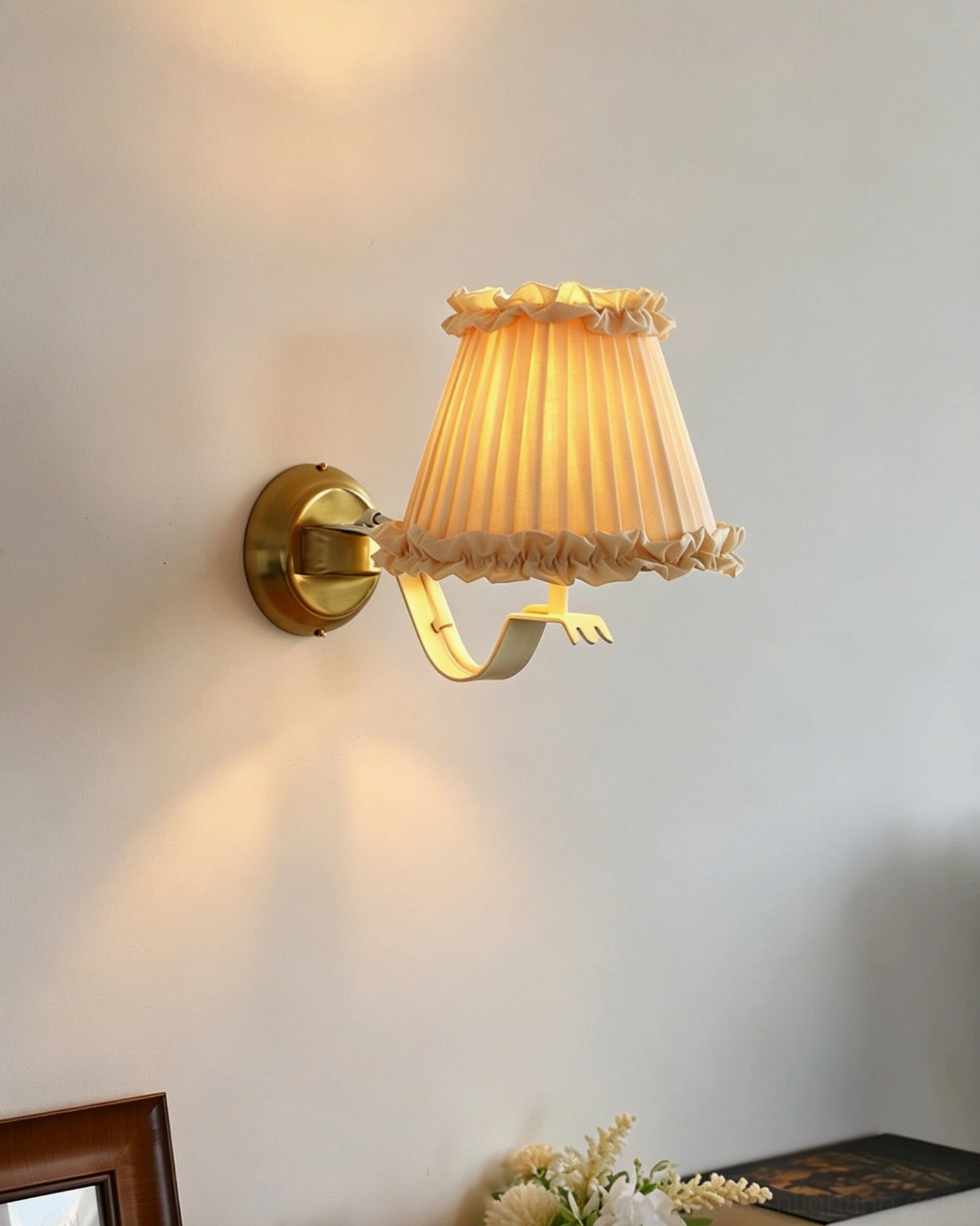 Chantal ruffle sconce right side view showing warm cream fabric shade and gold brass finish