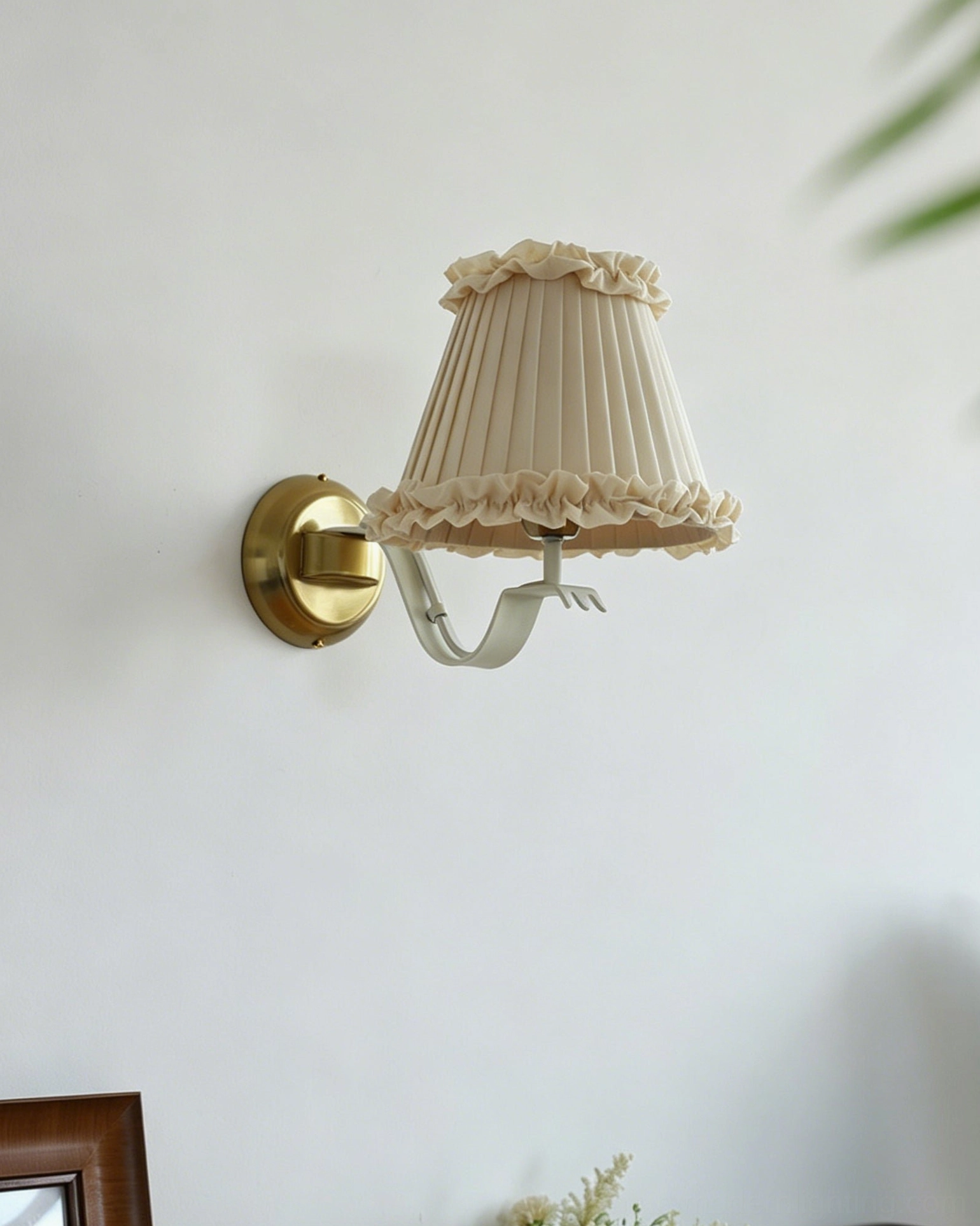 Unlit Chantal wall sconce with darker cream fabric shade on warm white wall background