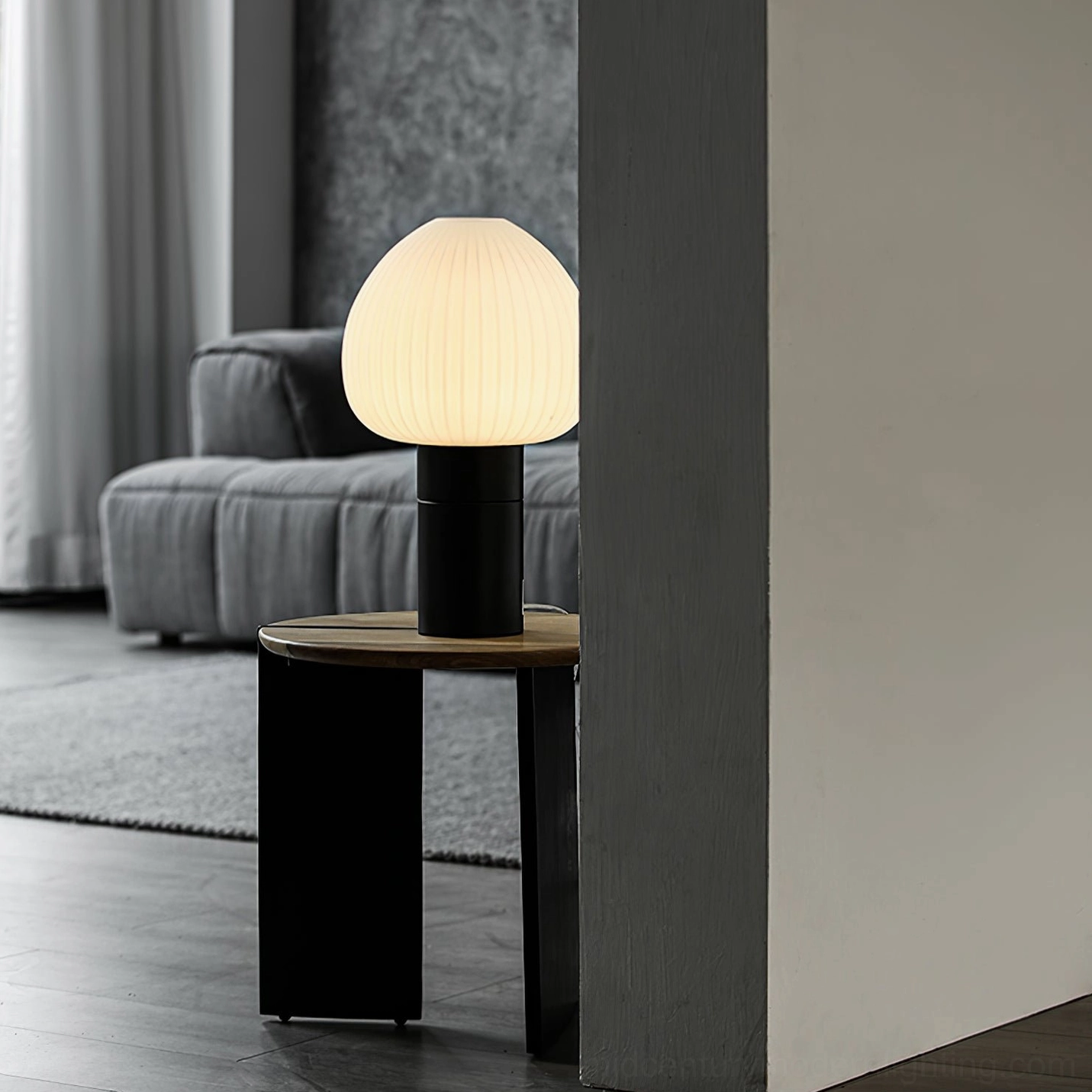 Chanya table lamp in modern living room corner emitting soft warm light, contemporary home décor accent