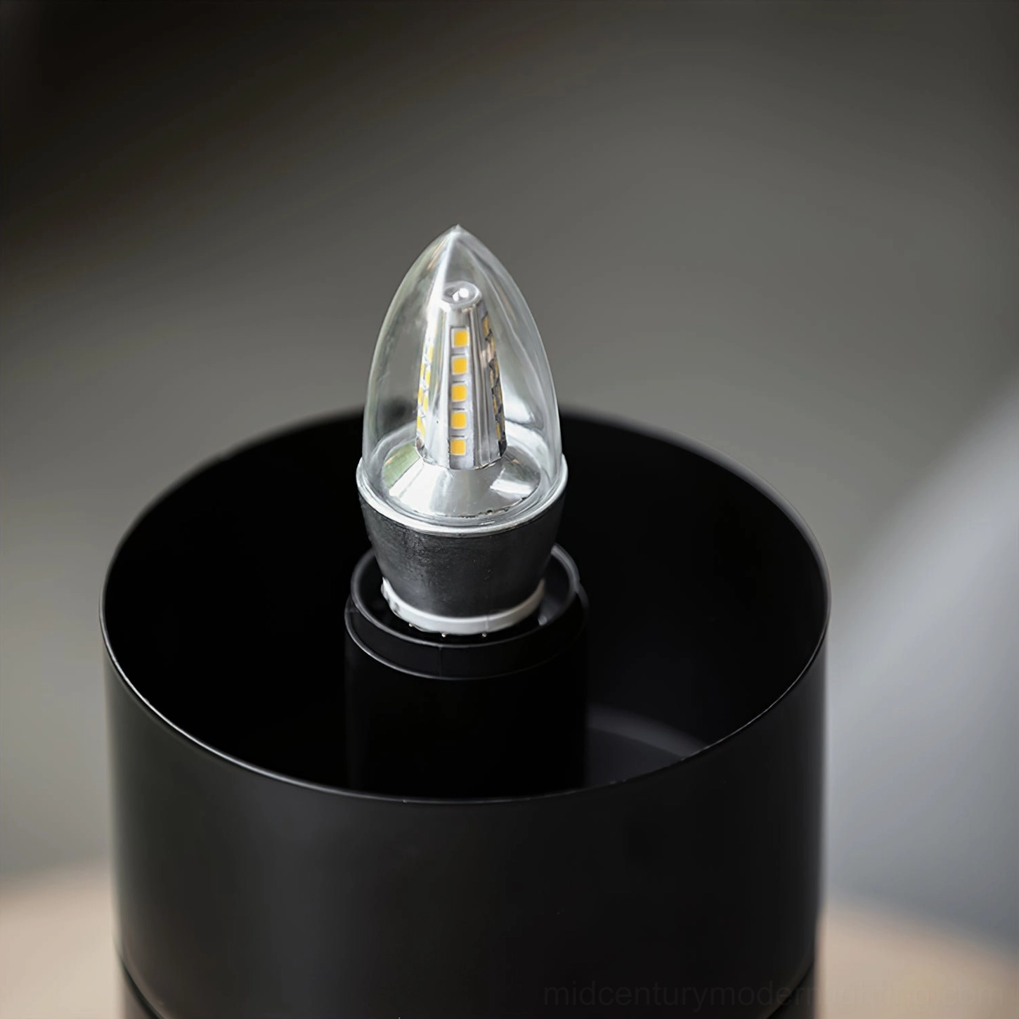 Chanya lamp internal structure detail showing LED candle bulb and black metal base socket close-up