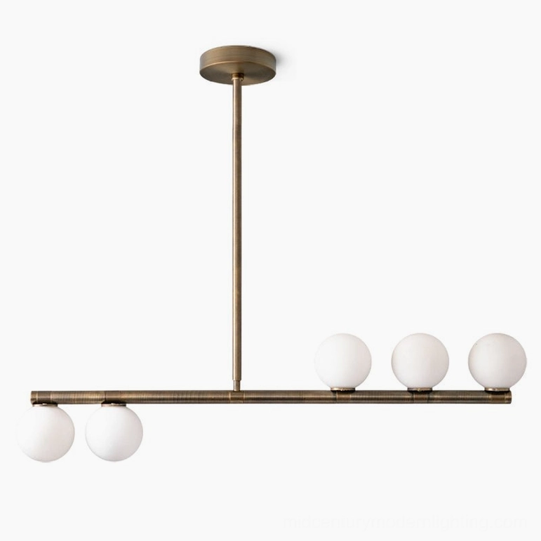 Complete Chelso 5-light horizontal brass chandelier with frosted white glass globes, installed interior view