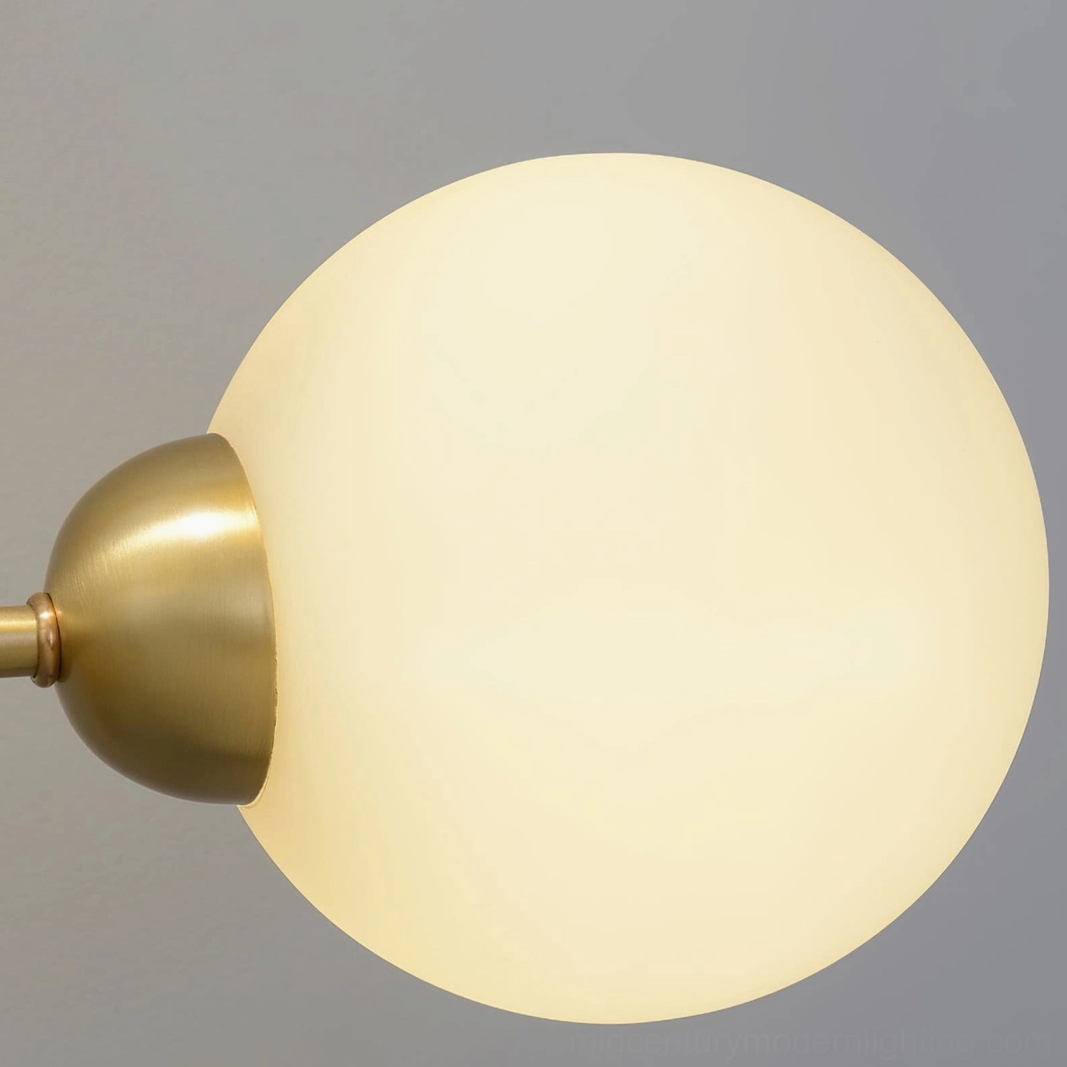 Chelso wall sconce architectural detail brass arms and glass shade connection
