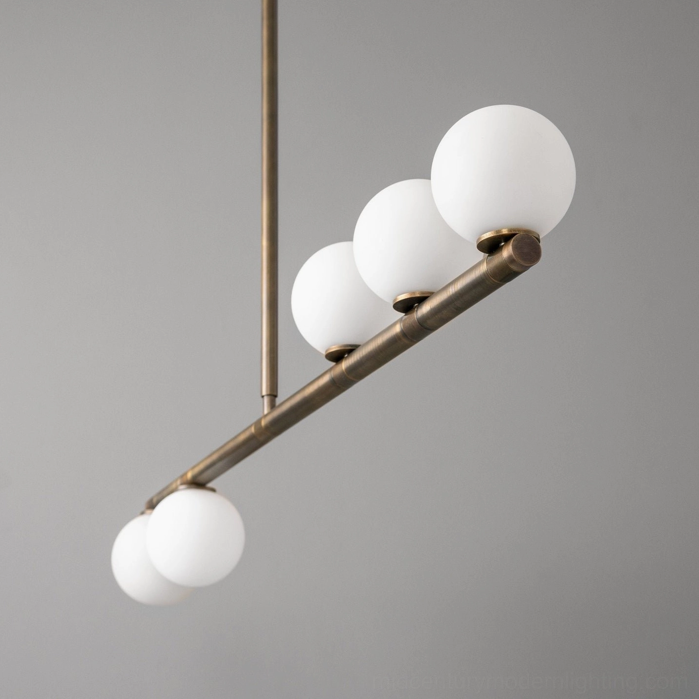 Side detail of Chelso linear chandelier showing clustered frosted glass orbs and exposed metal suspension rod