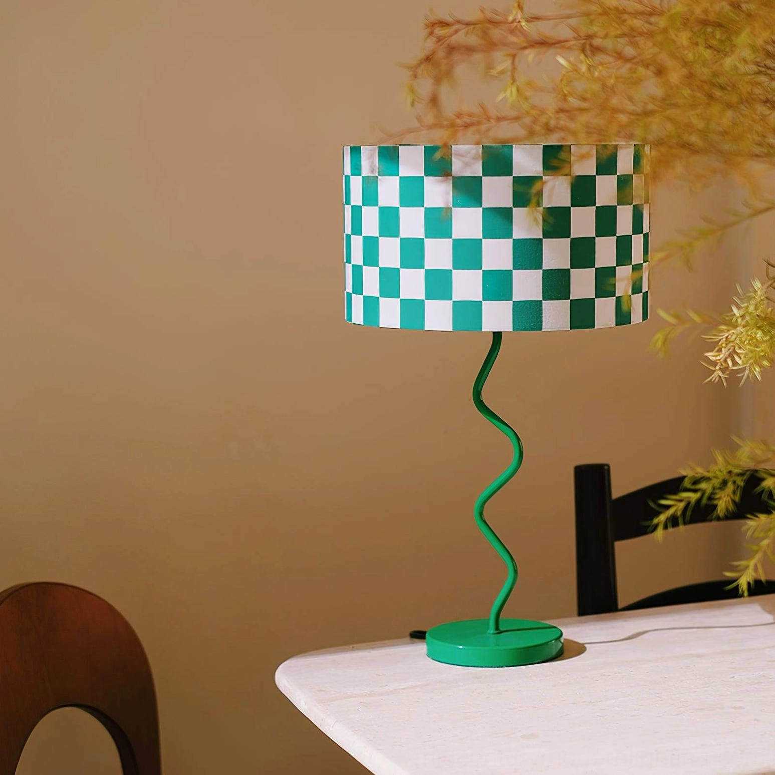 Green and white patterned fabric lamp shade on minimalist dining table with decorative plants