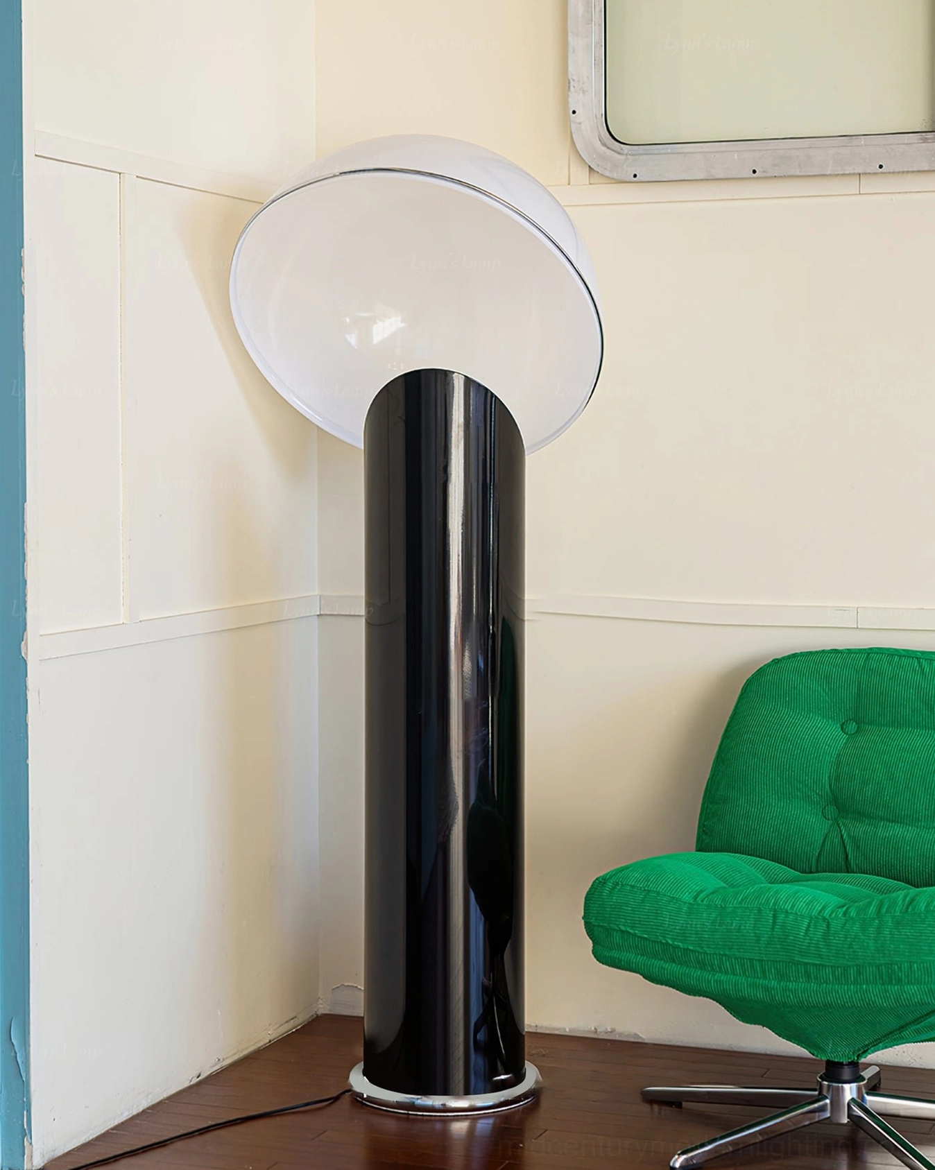 Ciot modern floor lamp side profile with angled white dome, positioned in vintage panel room with green accent chair