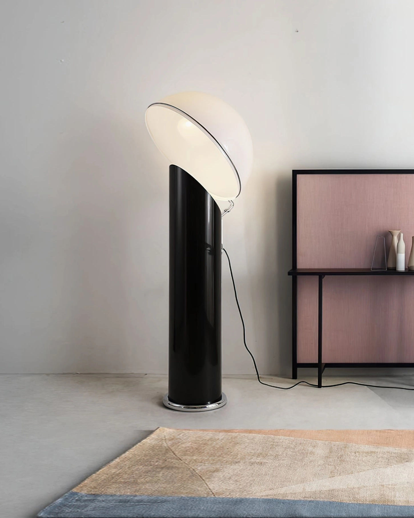 Ciot floor lamp side view illuminated with black glossy pole and tilted white acrylic dome in studio