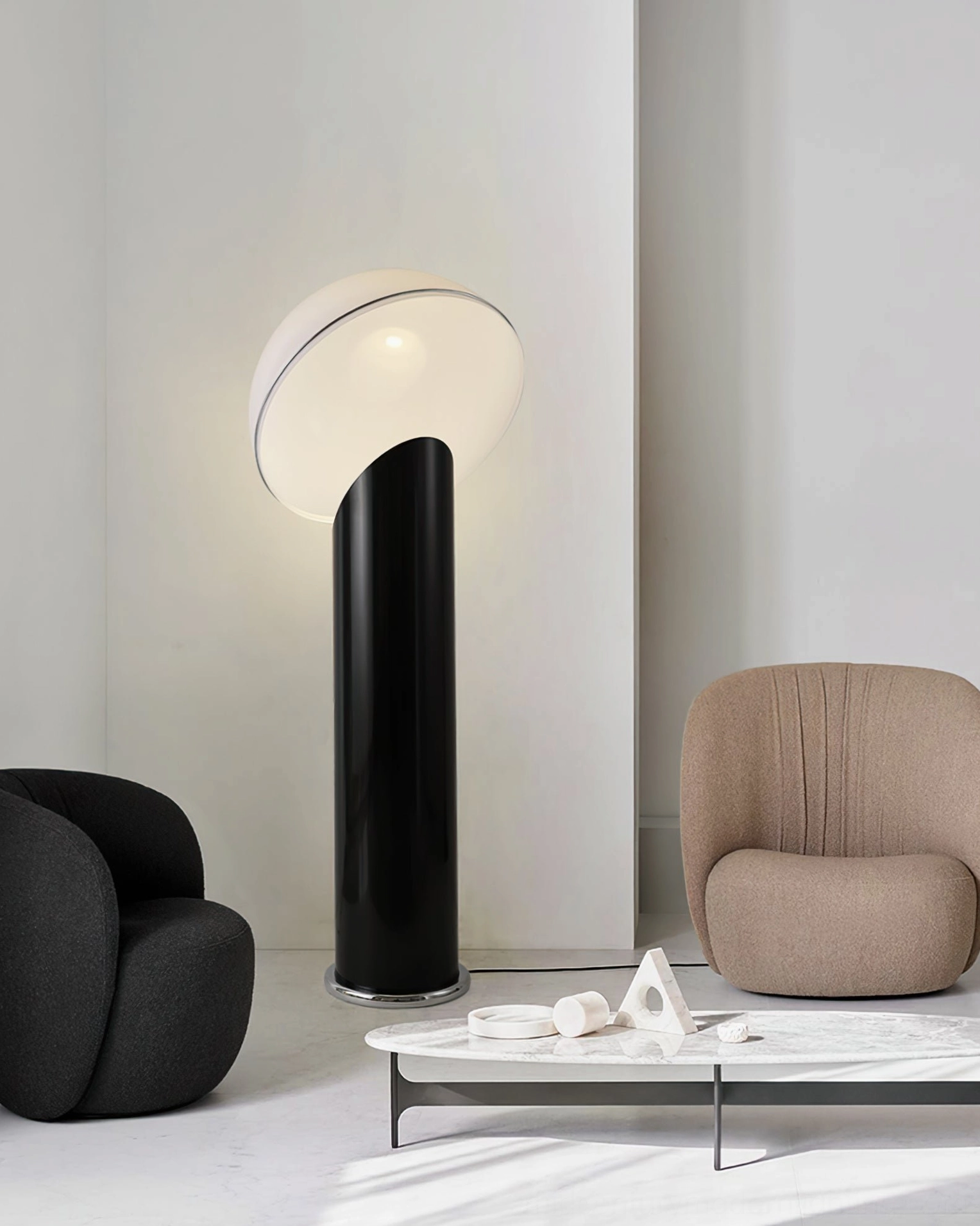 Ciot modern floor lamp illuminated in minimalist living room with curved white dome and black base