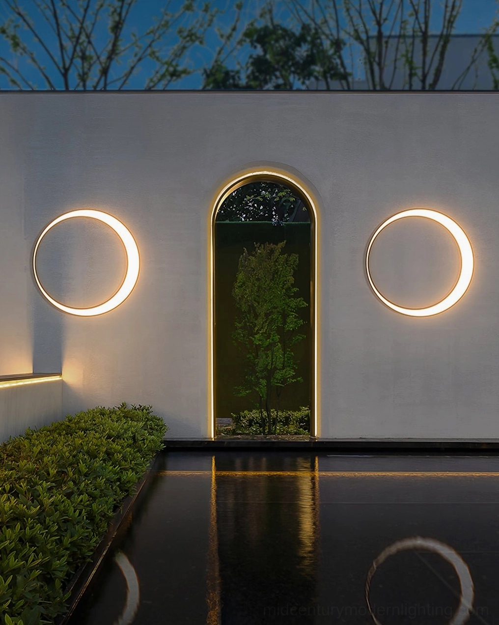 Circular LED outdoor wall lamp installation example on residential modern home exterior with warm light ambiance