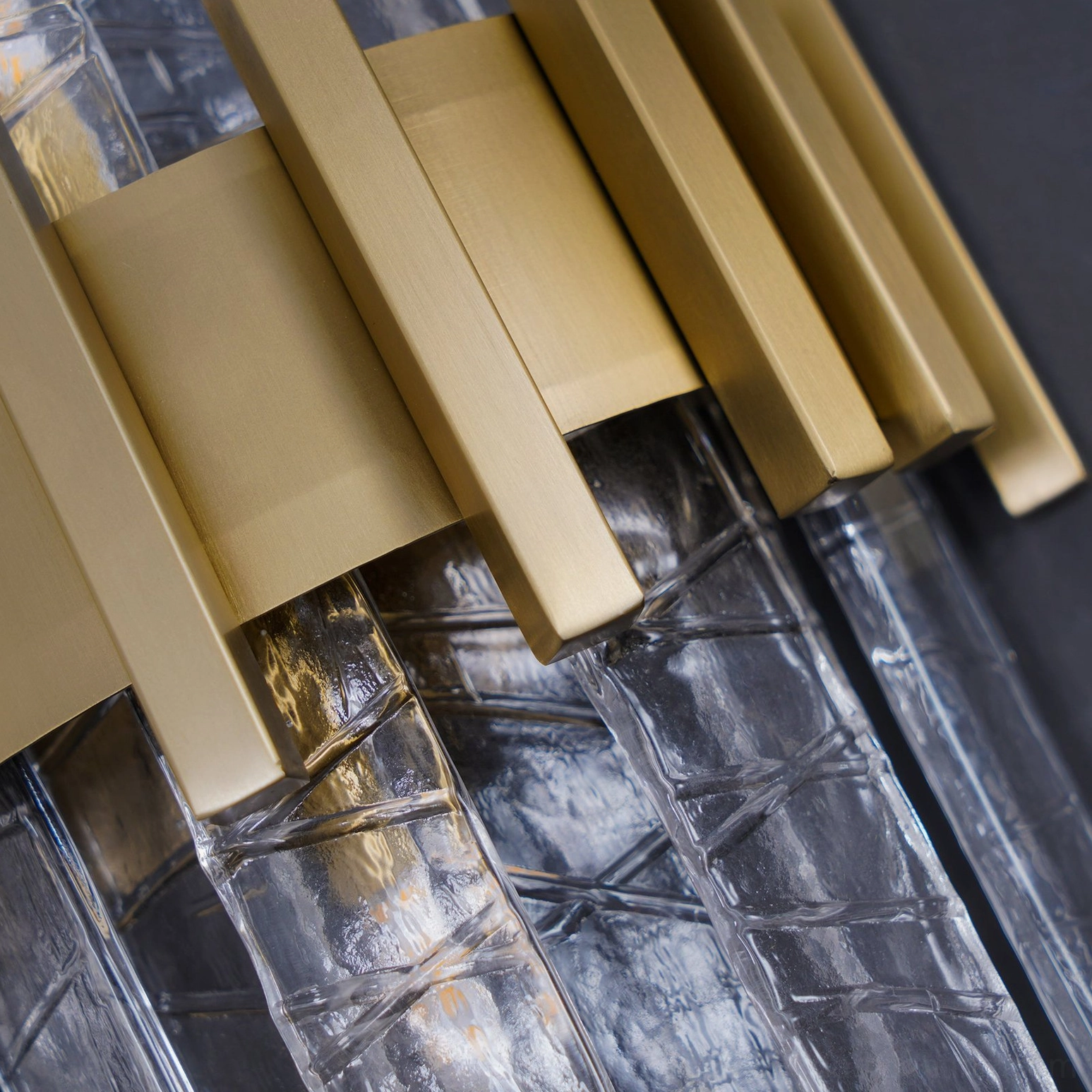 Brushed gold textured glass wall lamp styled in contemporary home setting