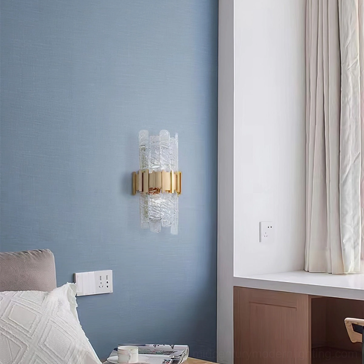 Modern luxury wall sconce with textured glass and brushed gold metal finish detail