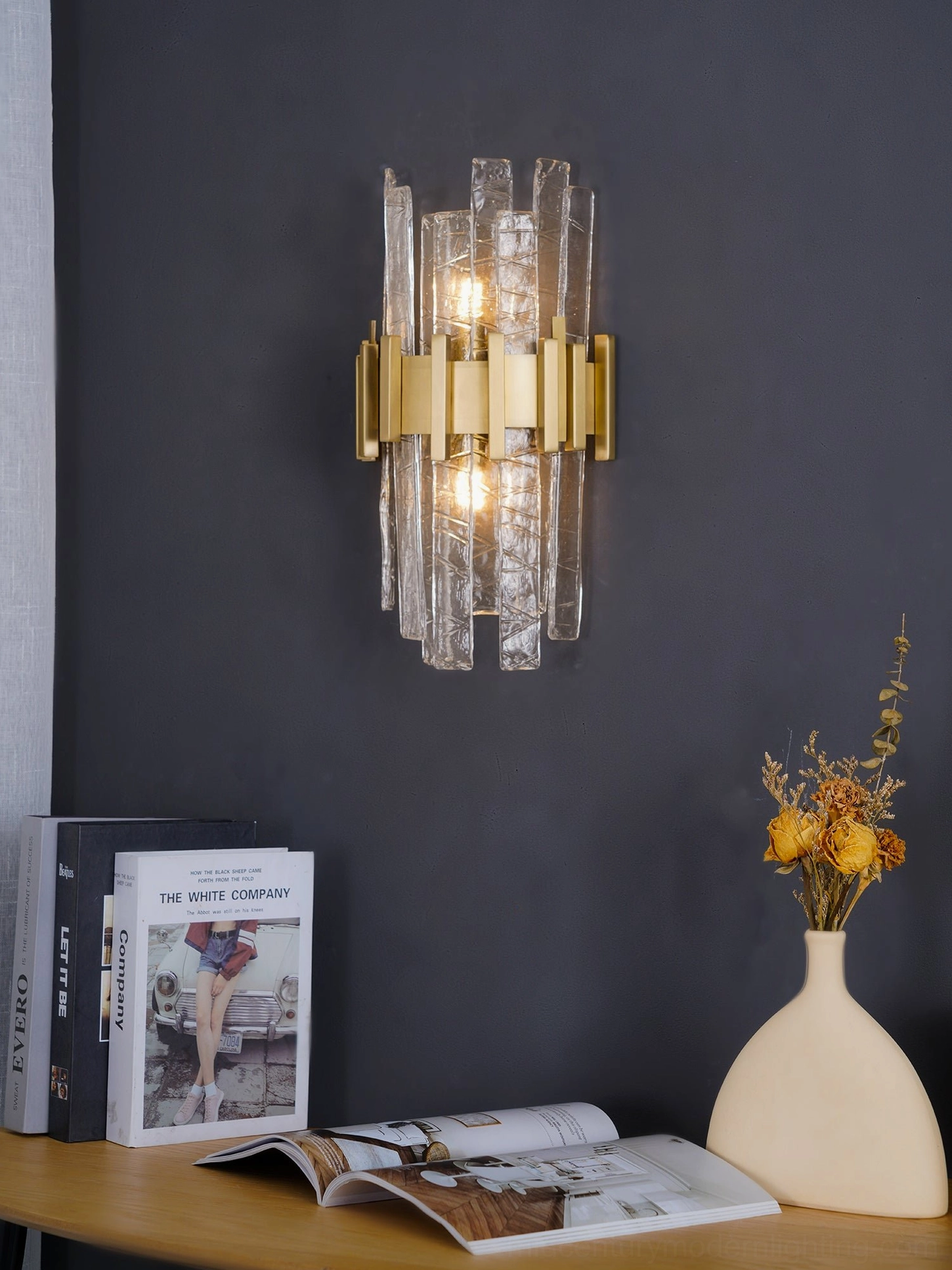 Contemporary gold metal wall lamp with dual warm lights, cozy interior styling