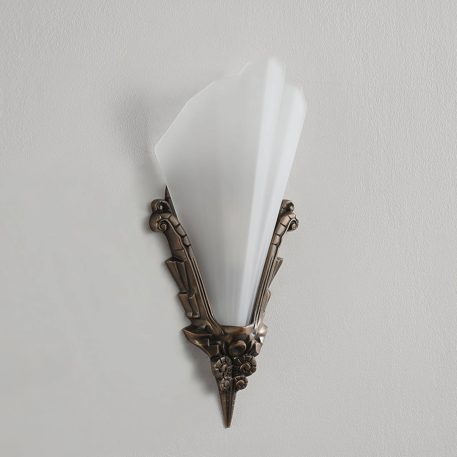 Claridge sconce profile view featuring narrow frosted glass cylinder and aged bronze mounting