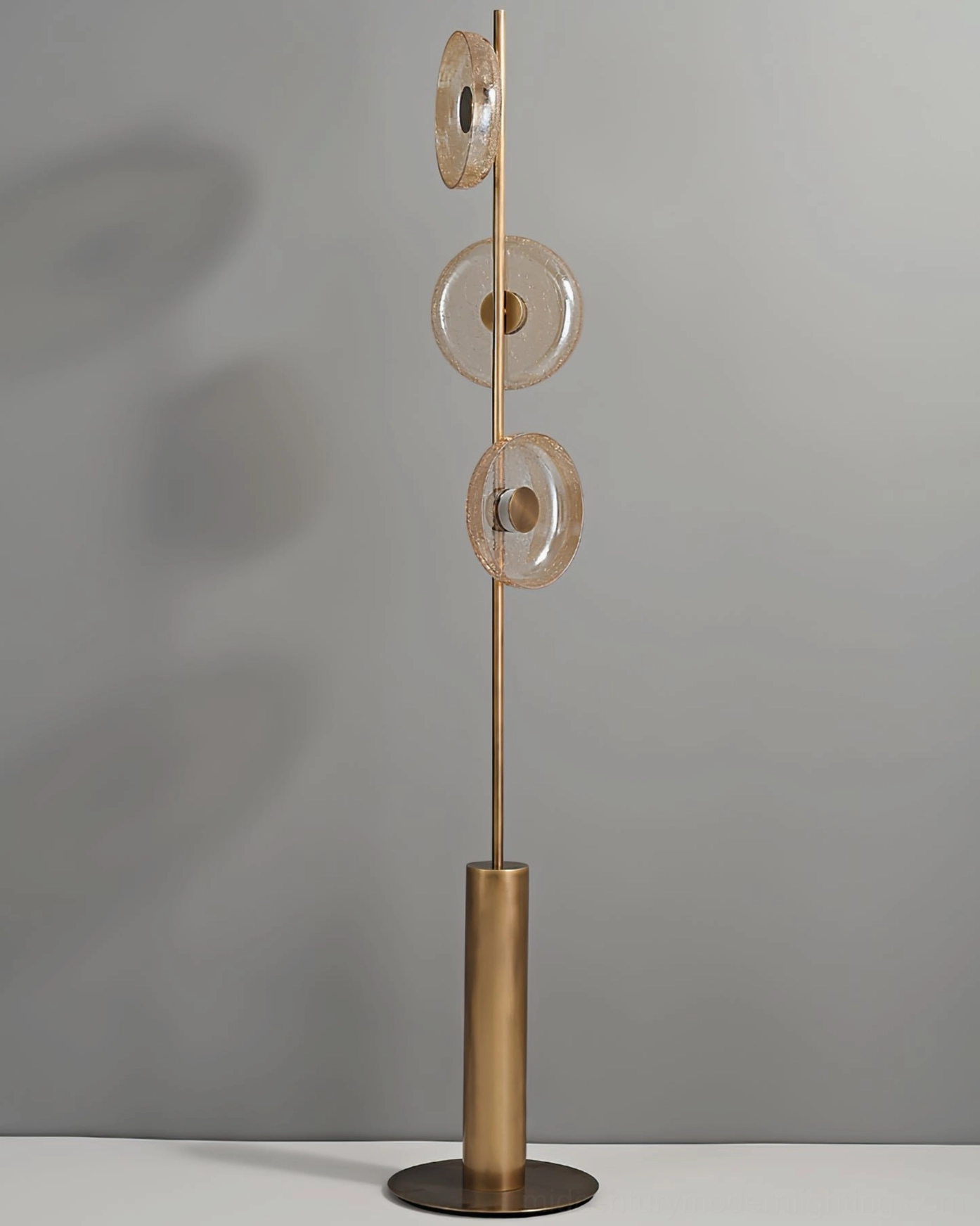 Crackle glass floor lamp with clear glass discs showing intricate fractured texture and light diffusion properties