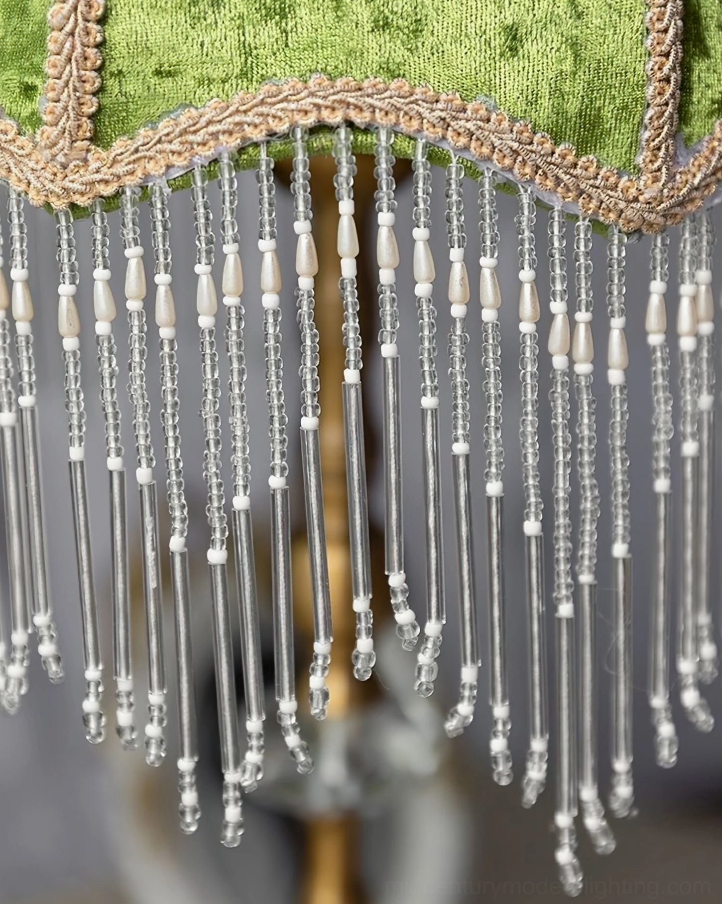 Clear finish velvet fringe table lamp with brass metalwork and precision-cut glass base