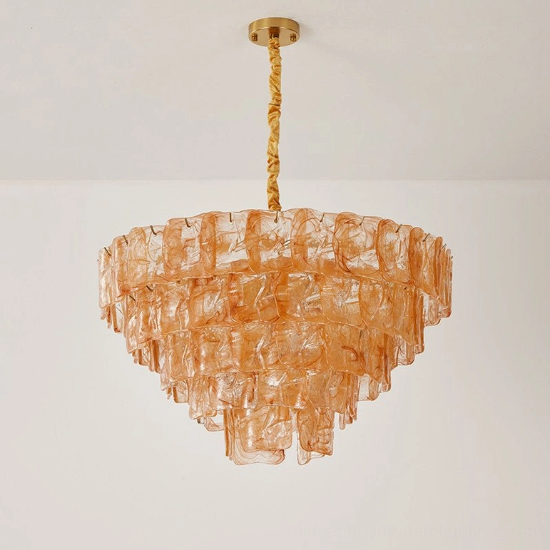 Tiered glass chandelier showcasing layered construction and light diffusion through textured glass, artistic pendant lighting sculpture