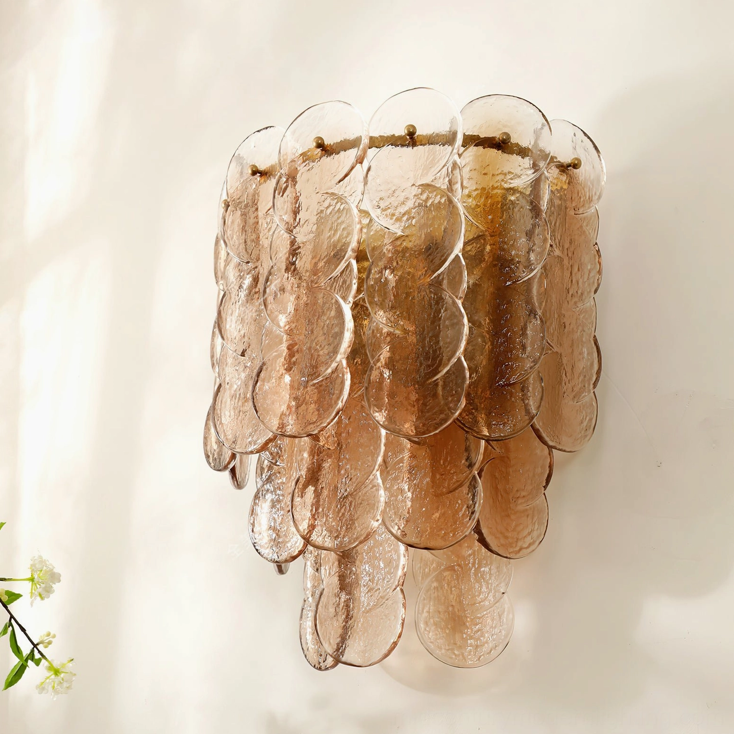 Close-up detail of rippled amber glass wall lamp panels with intricate texture