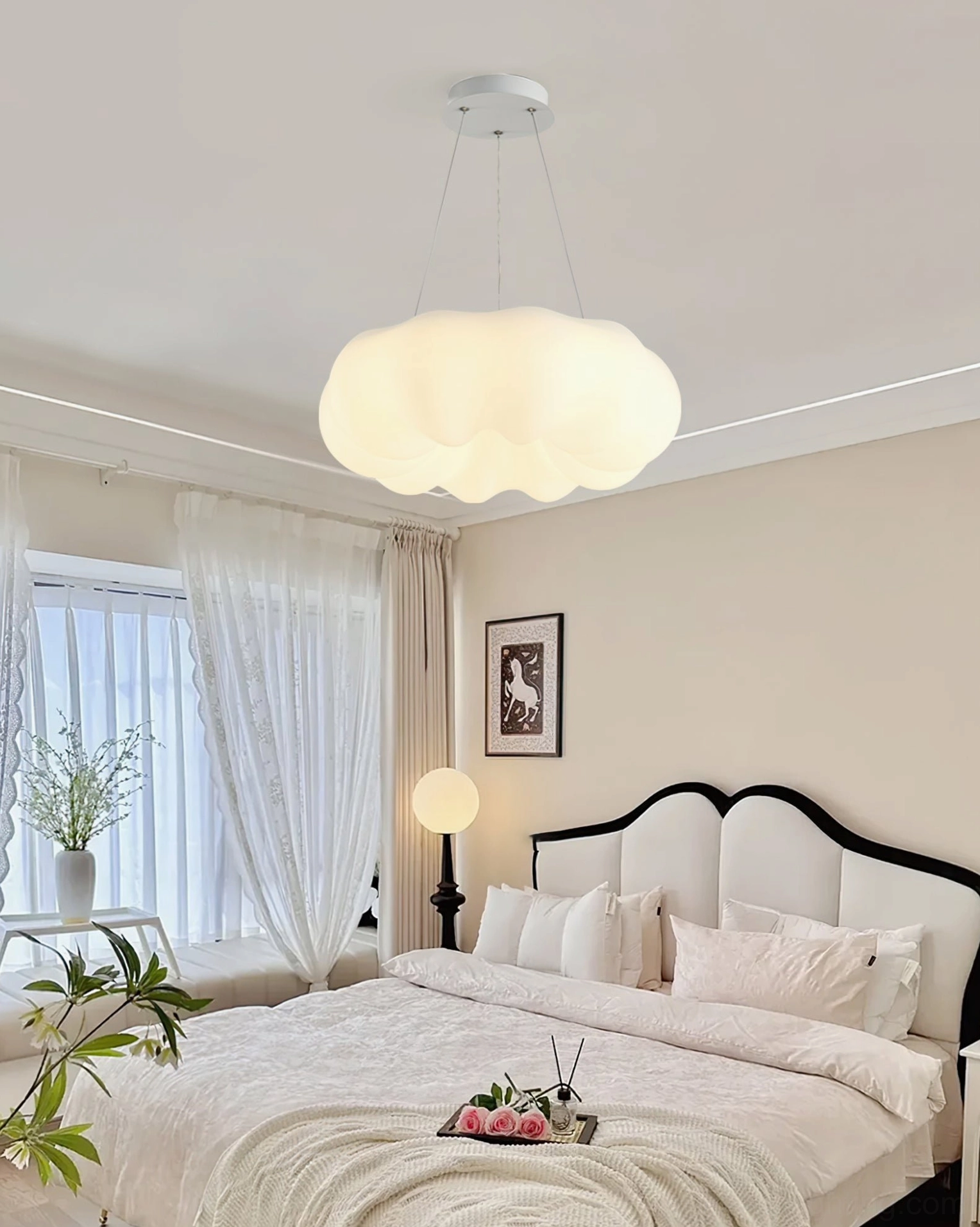 Cloud Kumo pendant hanging in minimalist master bedroom with upholstered bed