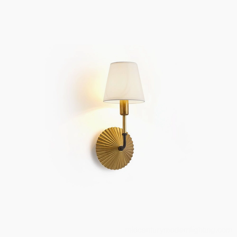 Clove brass wall lamp with pleated metal base and white fabric shade, front perspective view mounted on white wall, vintage luxury mid-century modern style
