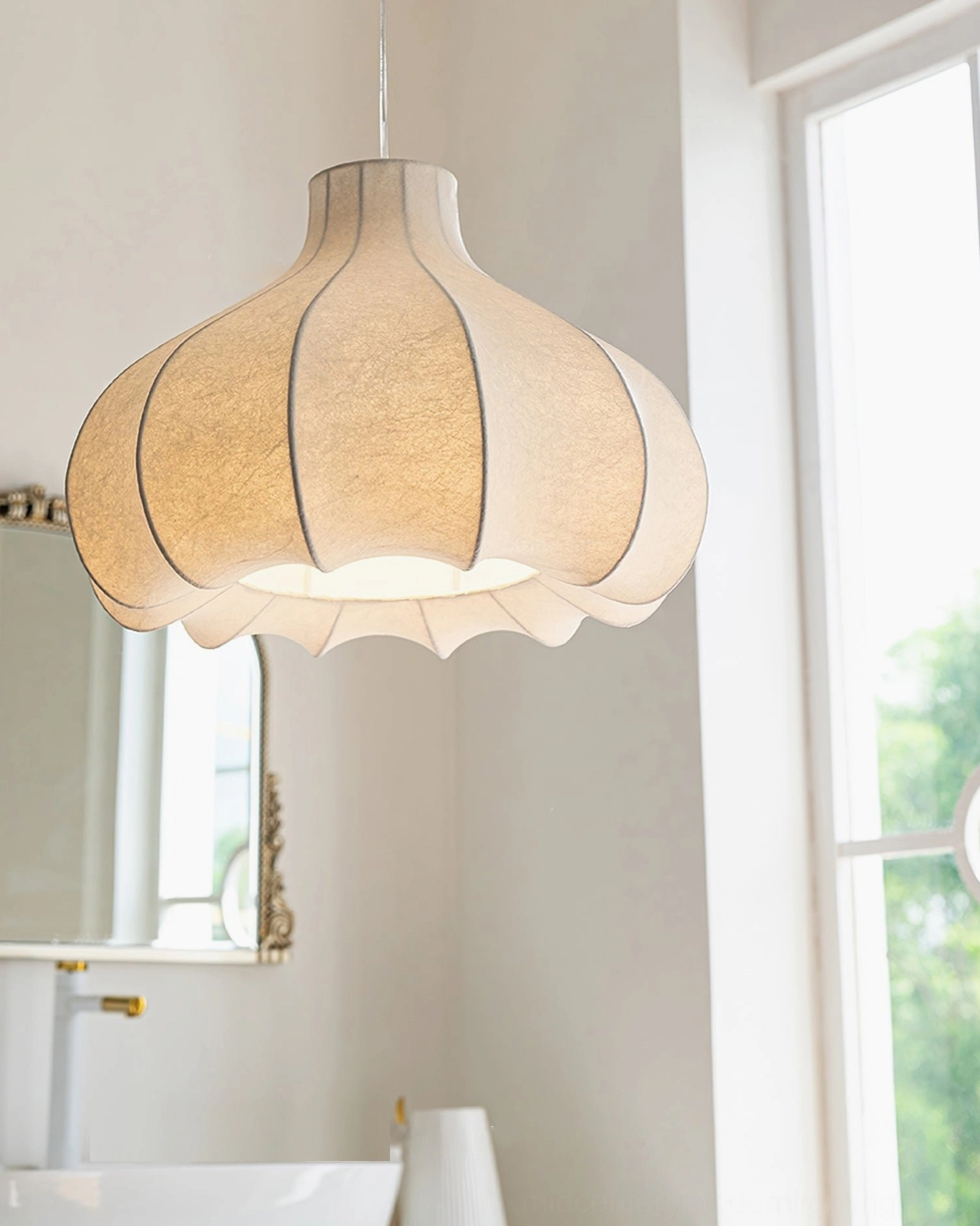 Wide beige fluted cocoon pendant lamp in bathroom setting, classic scallop silhouette with warm lighting glow