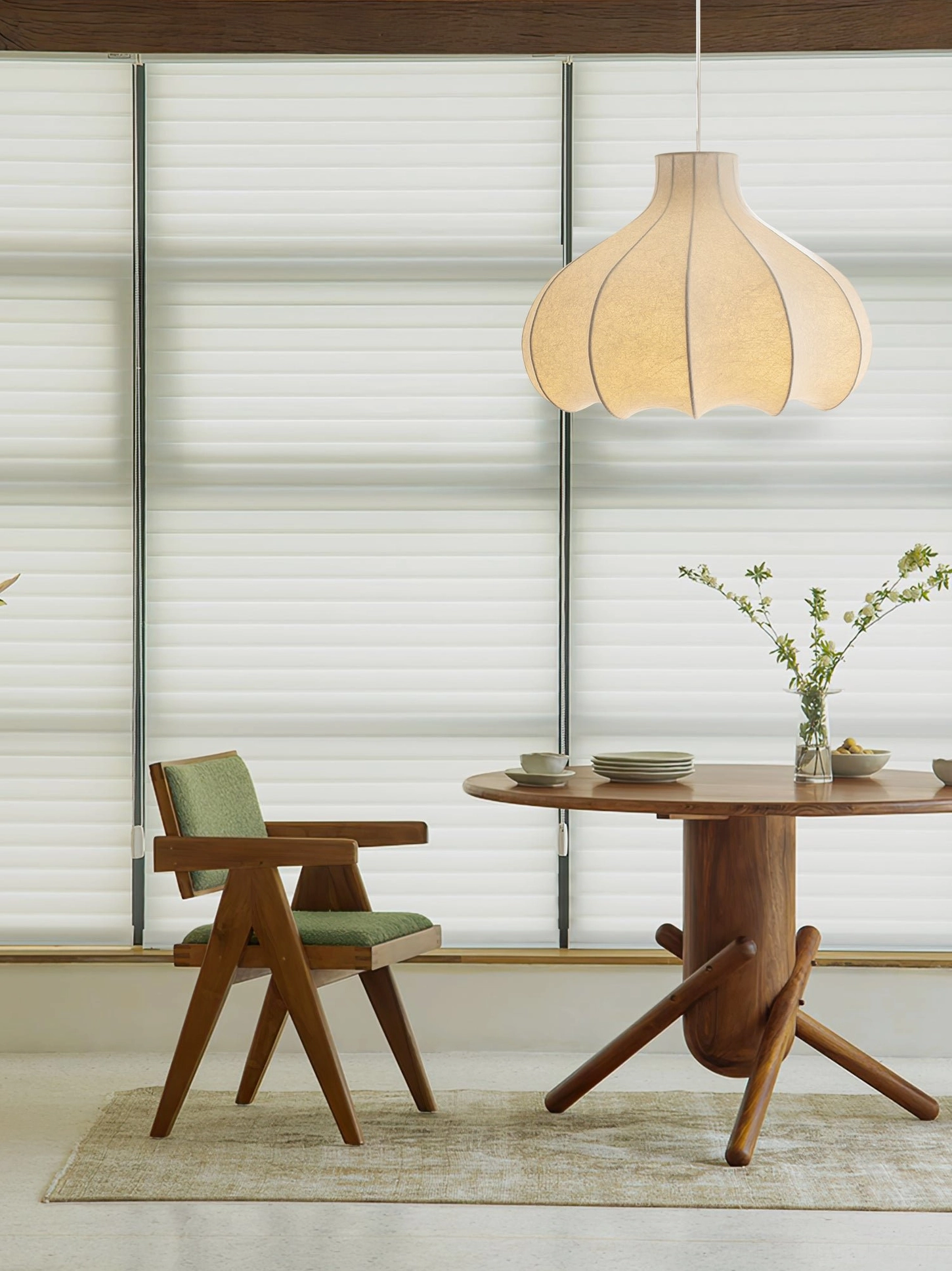 Beige scalloped cocoon pendant lamp hanging in wooden dining area, homey rustic minimalist interior styling