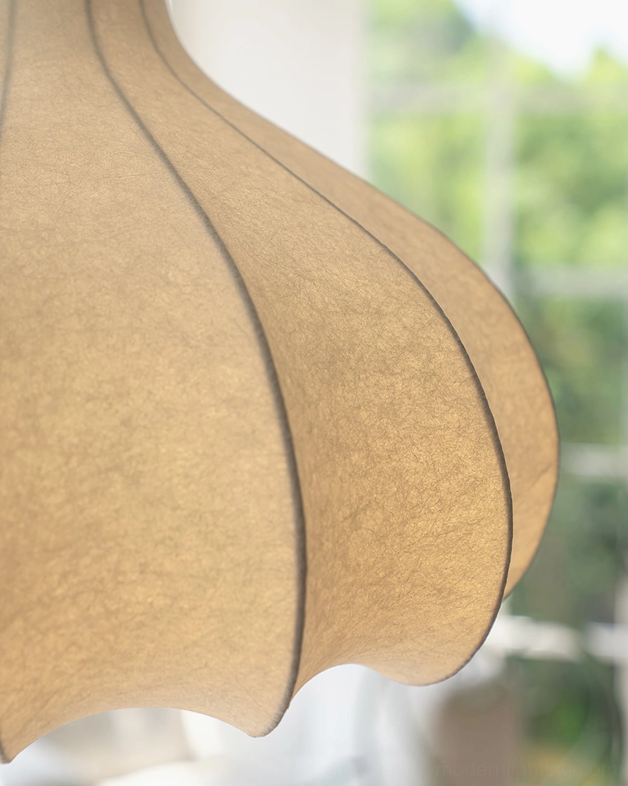 Close-up macro detail of cocoon silk pendant lamp shade texture showing pleated fabric and seam construction