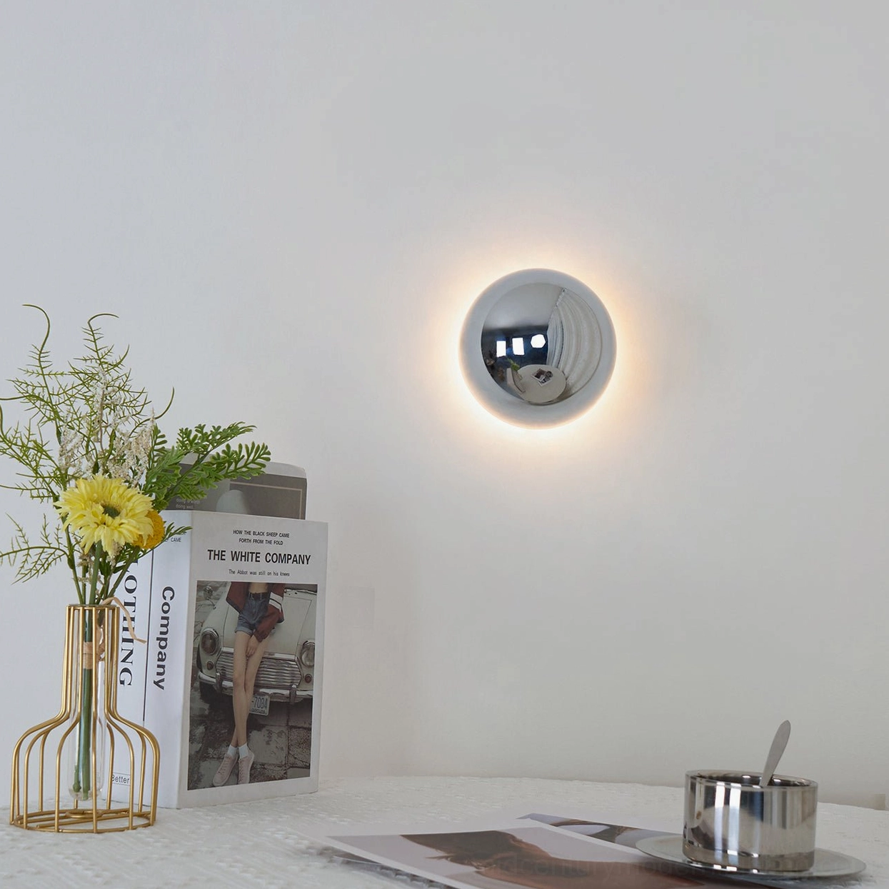 Compact adjustable wall sconce with integrated LED in modern home interior setting