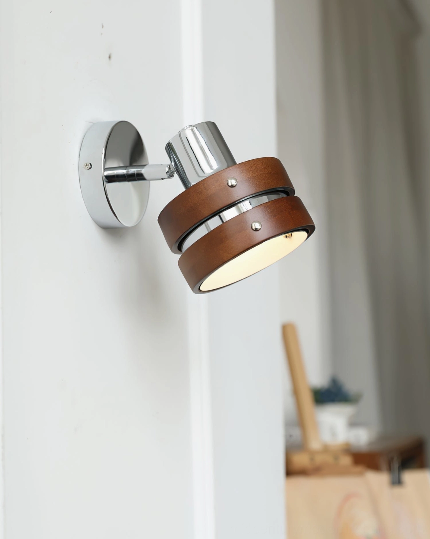 Compact mid-century modern wall sconce in home corner with contemporary furnishings