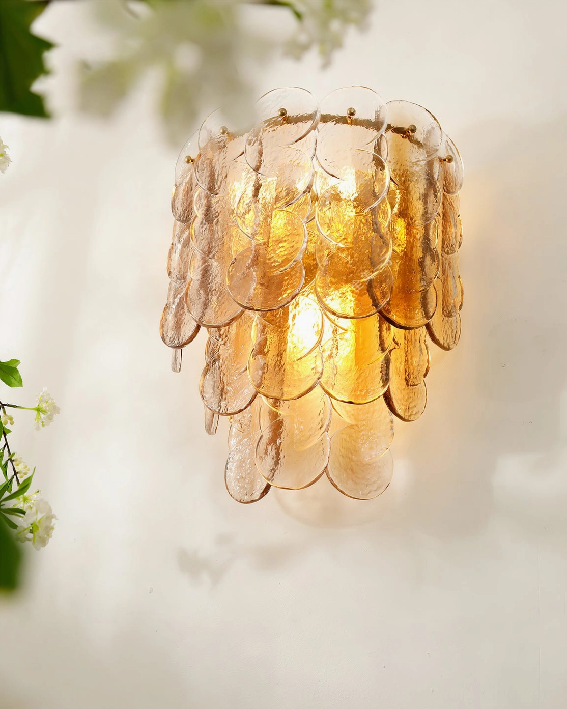 Compact tiered glass wall lamp with textured panels creating warm ambient lighting