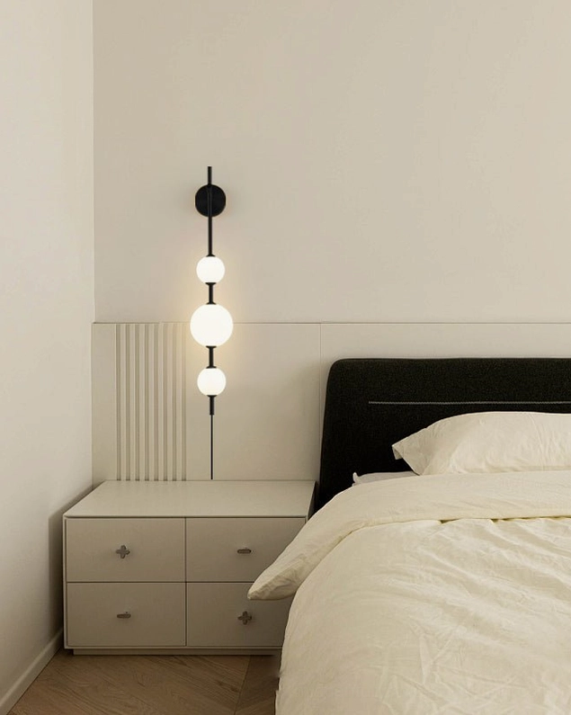 Compact two-globe vertical wall sconce in brass, minimalist mid-century modern lighting fixture