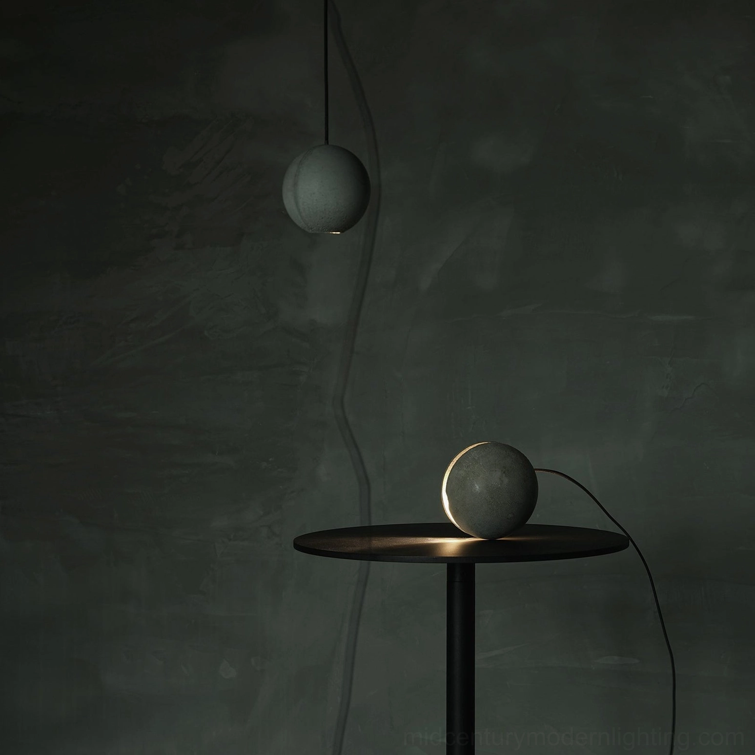 Concrete pendant lamp collection displaying various hemisphere and split-sphere designs in natural studio lighting
